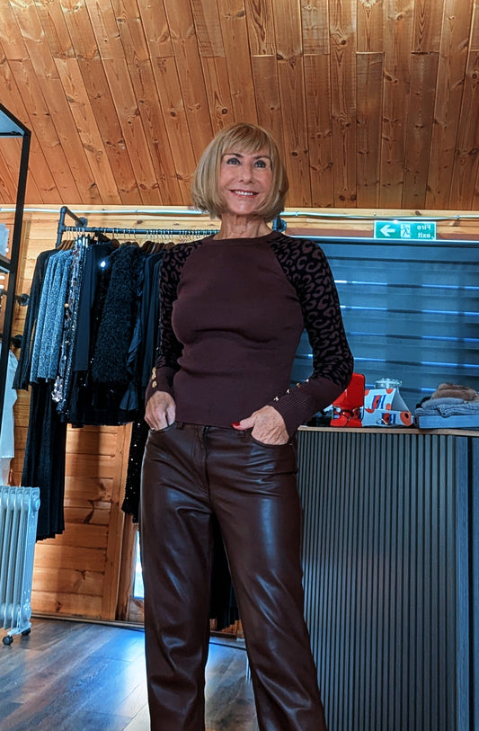 Closer front view of the Julia chocolate sweater, showing its round neckline and leopard print sleeves