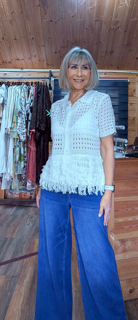 Cream open knit crochet top styled with light denim jeans