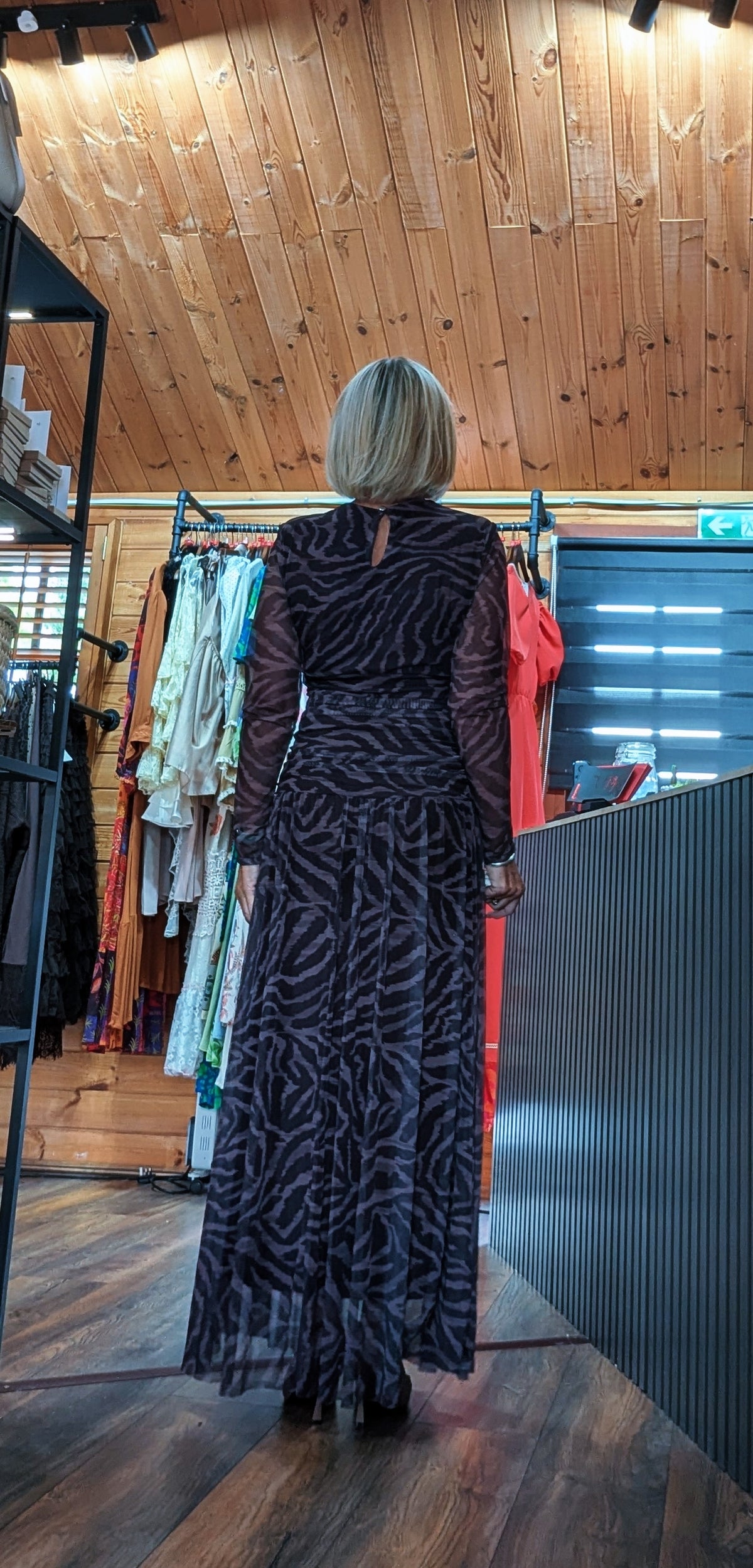 Rear view One size animal print maxi dress in chocolate or burgundy with cowl neck and sheer long sleeves
