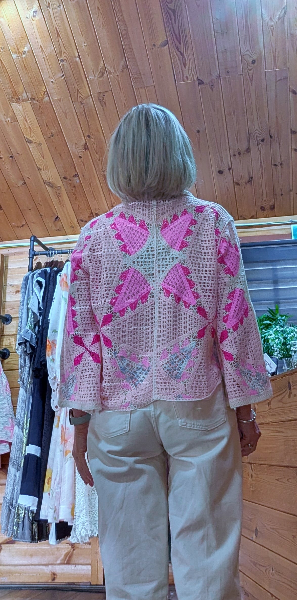 Helen pink crochet cardigan styled with jeans rear view