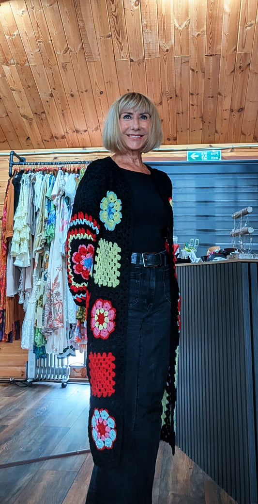 ditsydi wearing the Fia colourful crochet flower cardigan with a black top and trousers