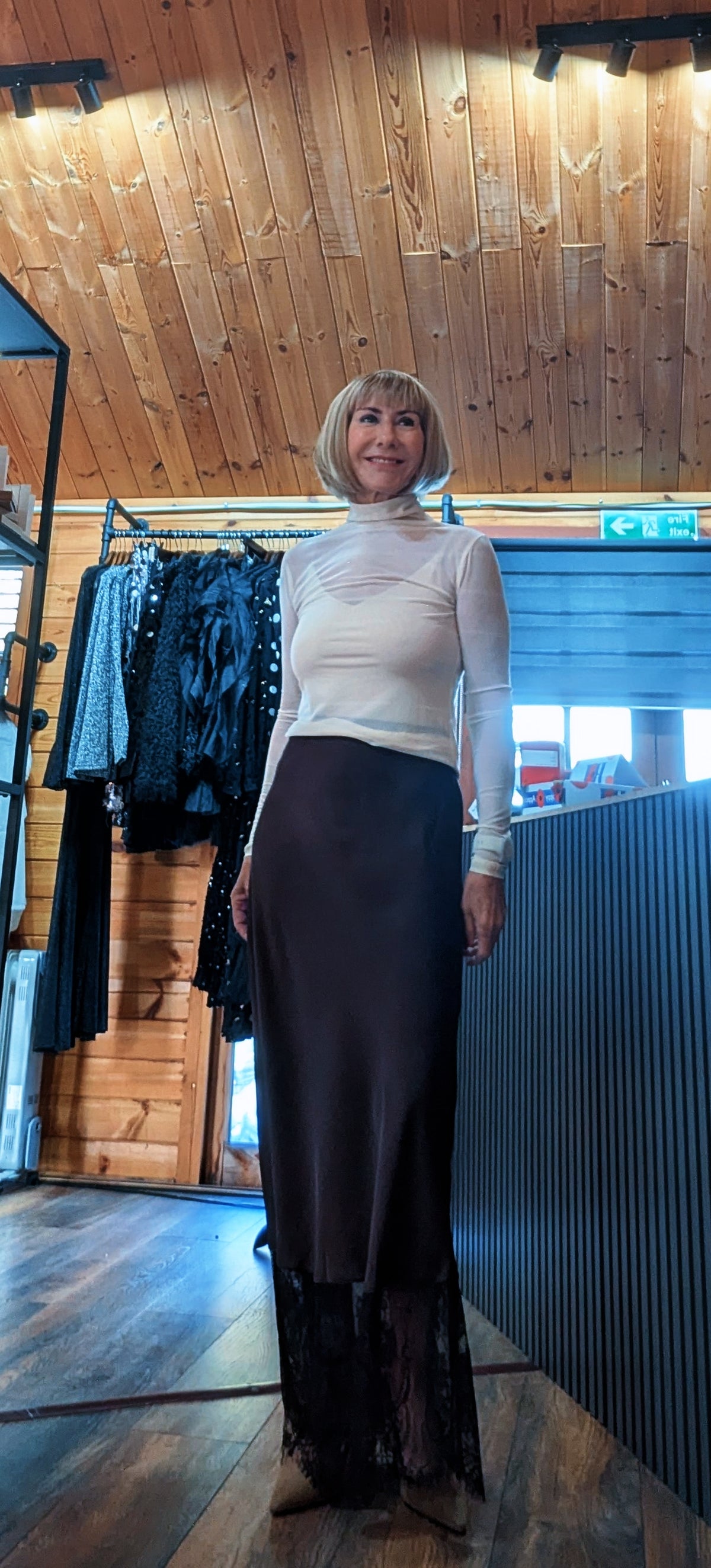 Di wearing the Lumine chocolate satin slip skirt with a sheer lace hem and an ivory top