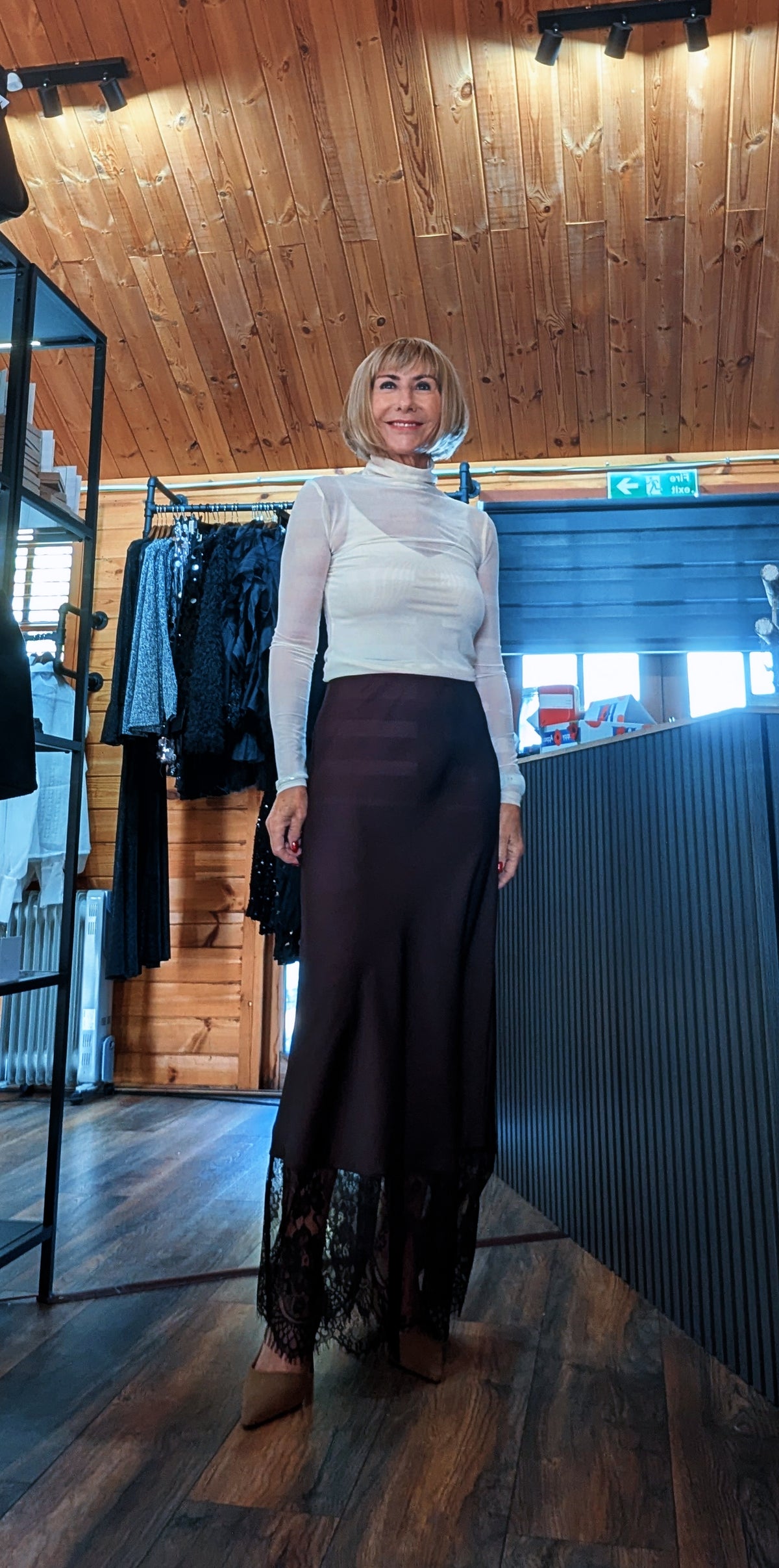 Lumine chocolate satin skirt worn with a fitted ivory top and pointed shoes
