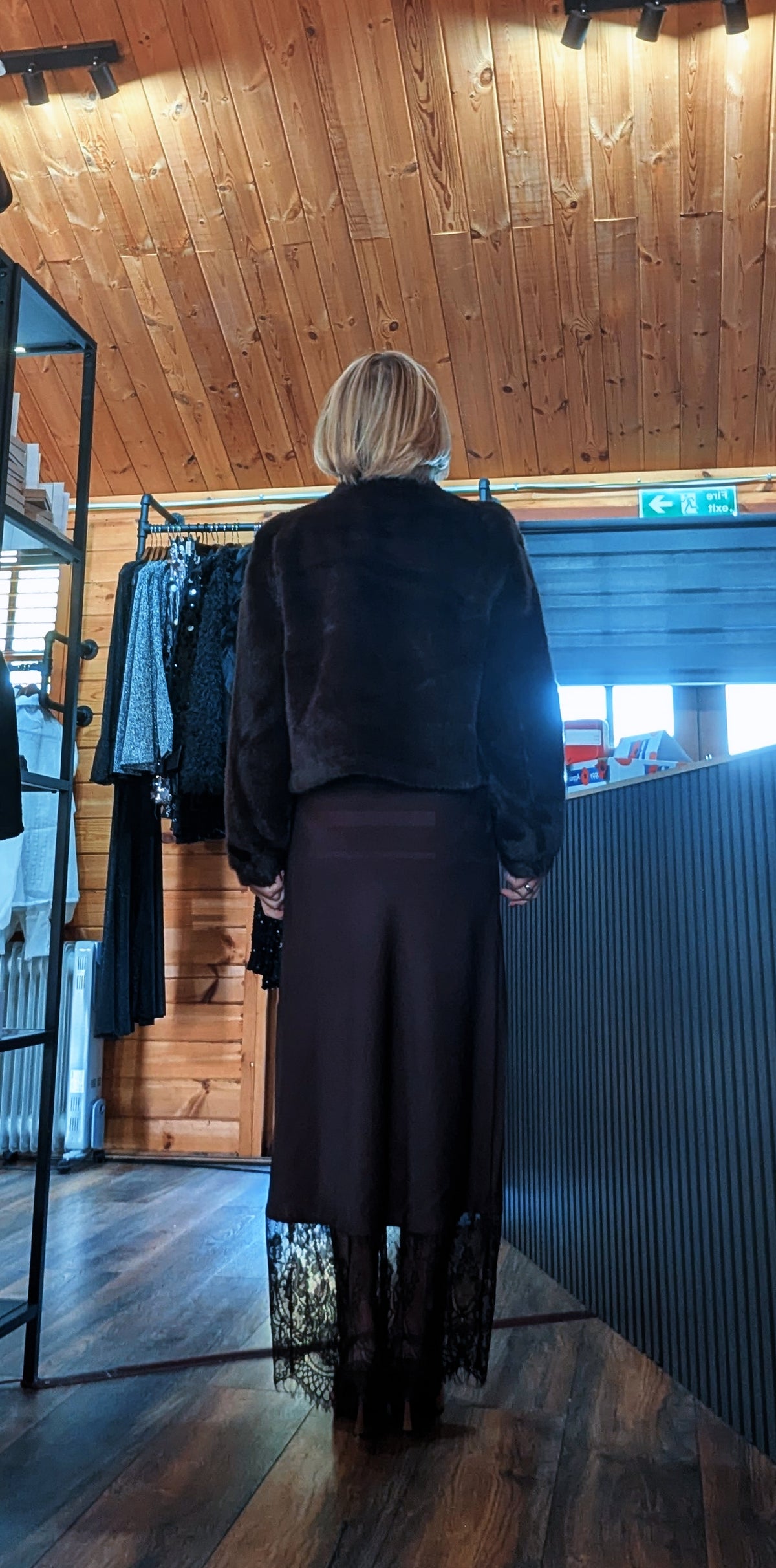 Back view of the Lumine lace hem skirt styled with the Bessie faux fur jacket