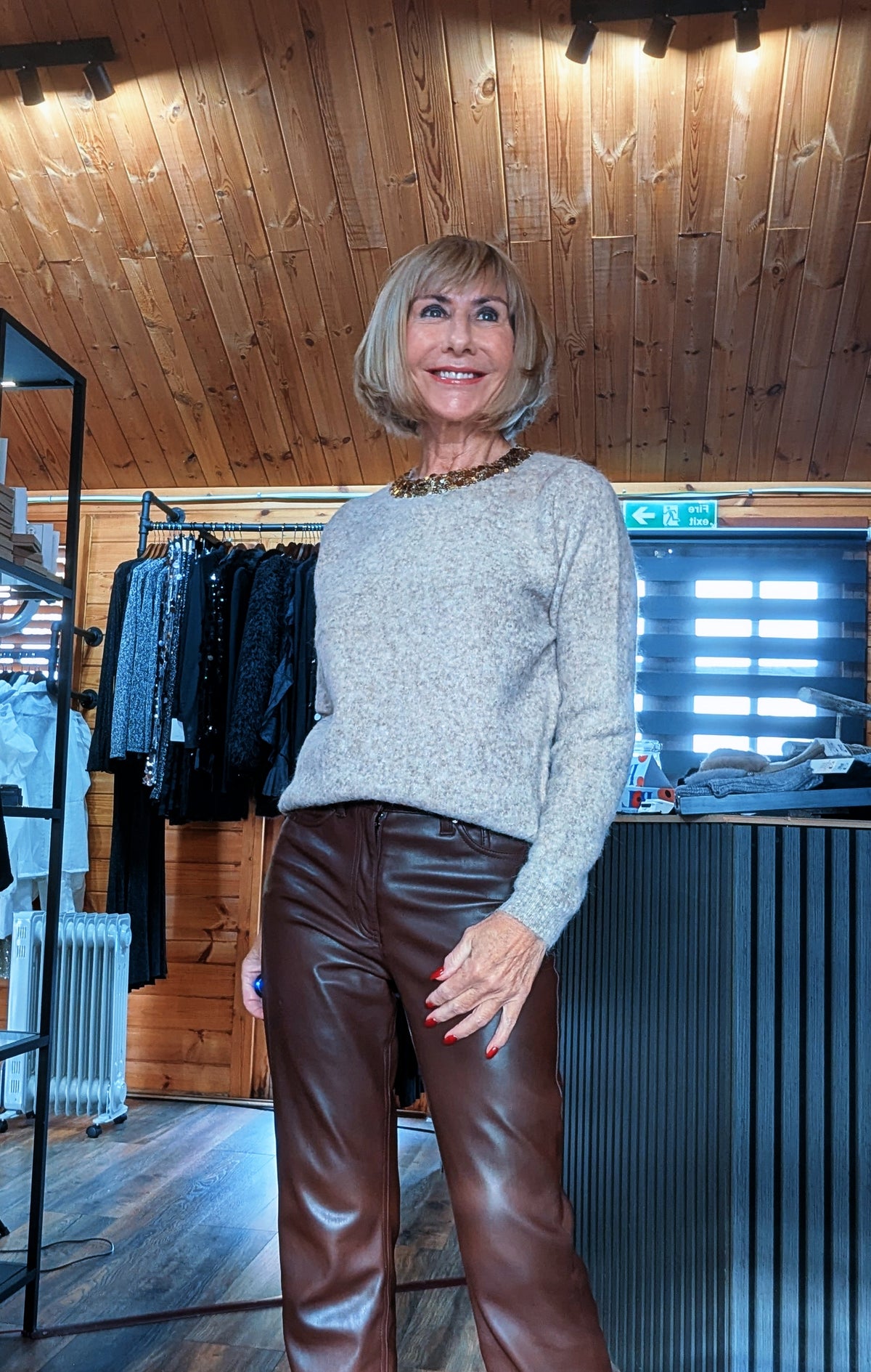 Closer view of the Pixie taupe knit jumper, showing the gold embellished round neckline