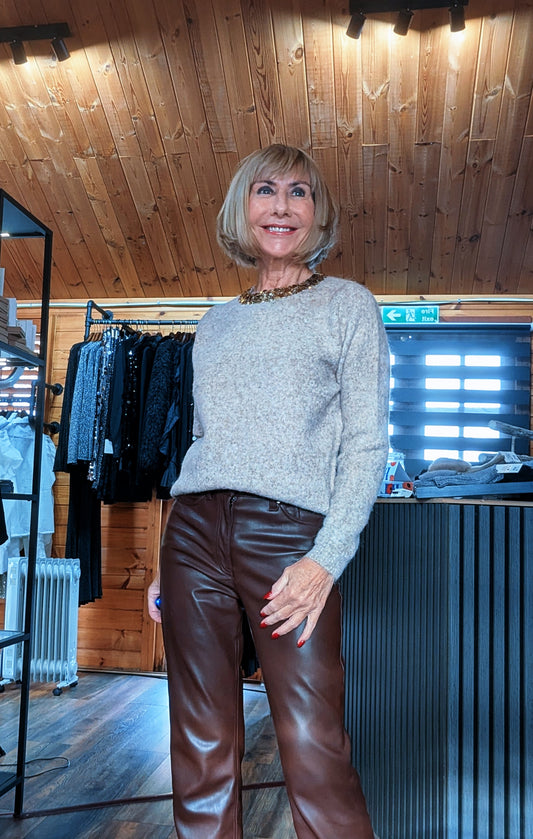 Closer view of the Pixie taupe knit jumper, showing the gold embellished round neckline