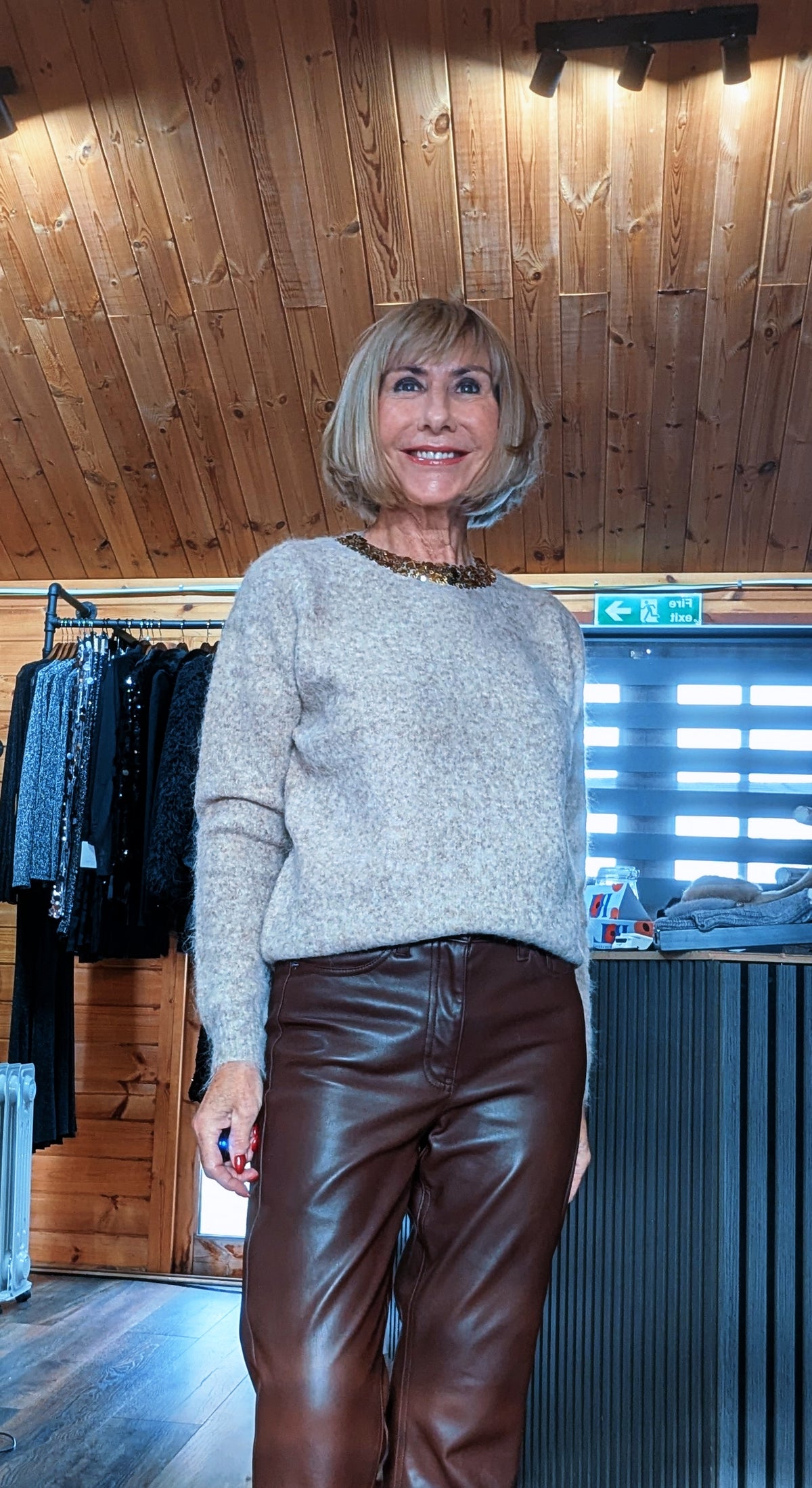 Detail view of the Pixie taupe jumper, showing its embellished neckline and soft knit