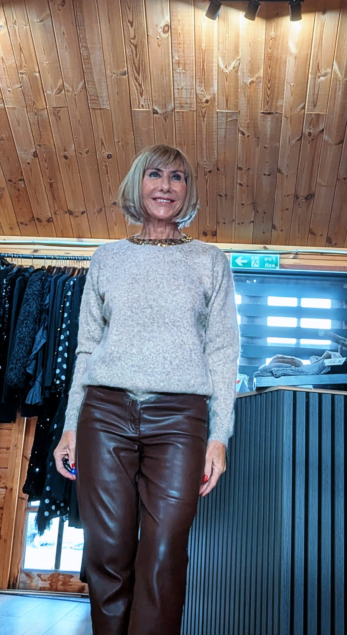 Closer front view of the Pixie jumper, showing its gold neckline detail and ribbed hem