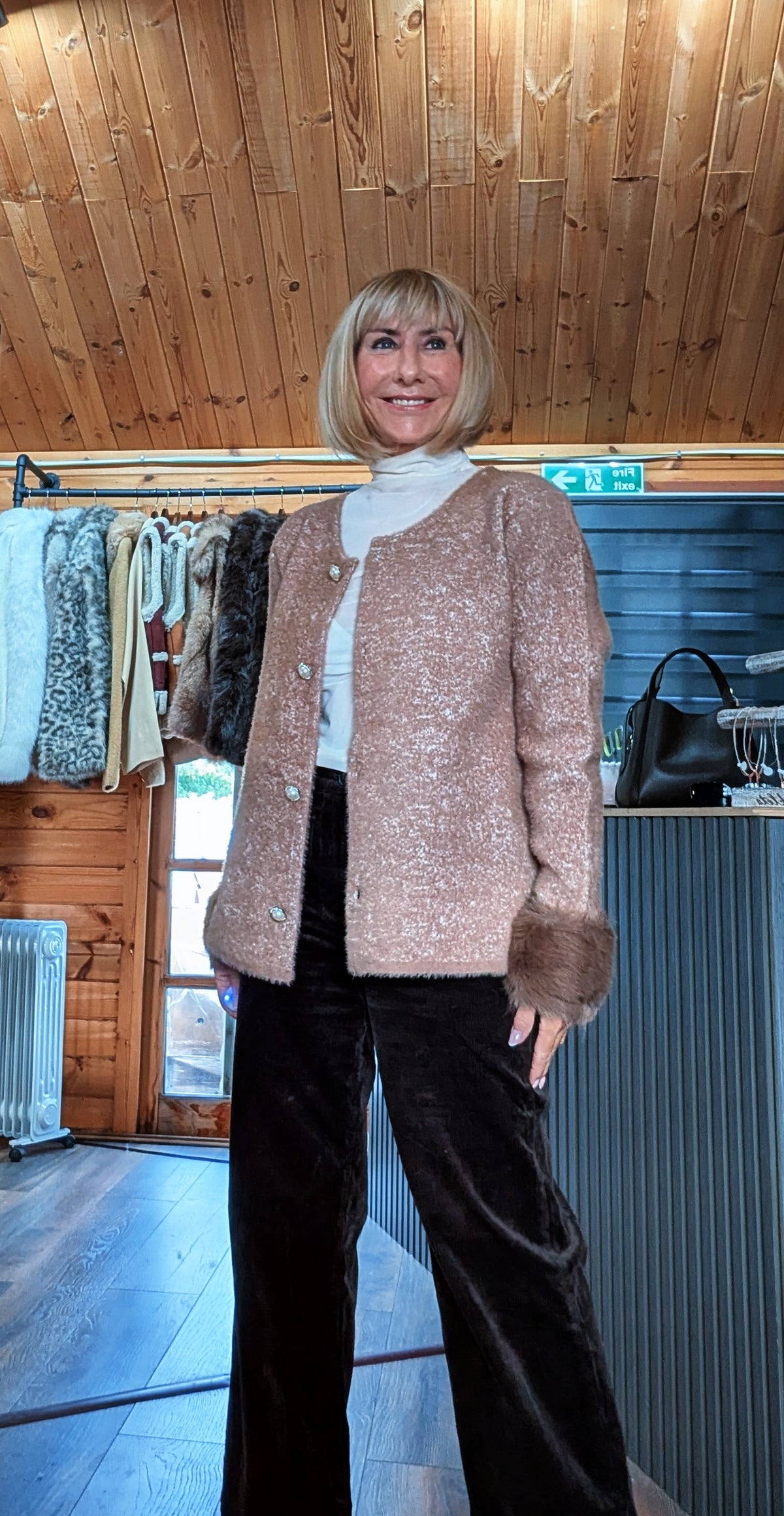 Liv chocolate cardigan worn open, showing the textured knit, decorative buttons and fluffy cuffs