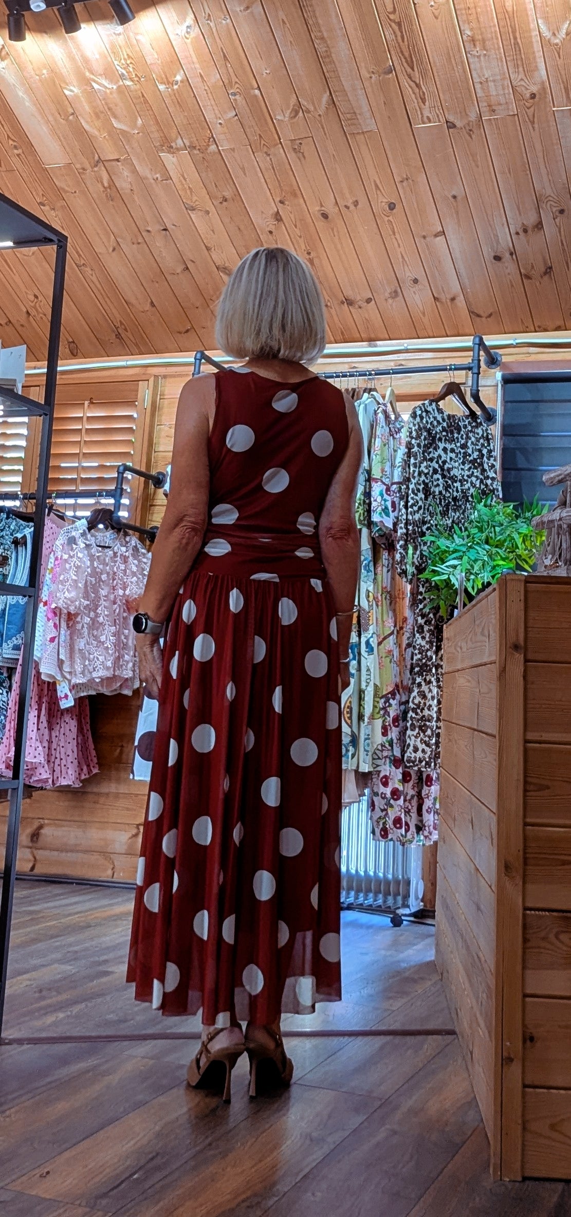 Rear view of the Rumer sleeveless polka dot occasion dress