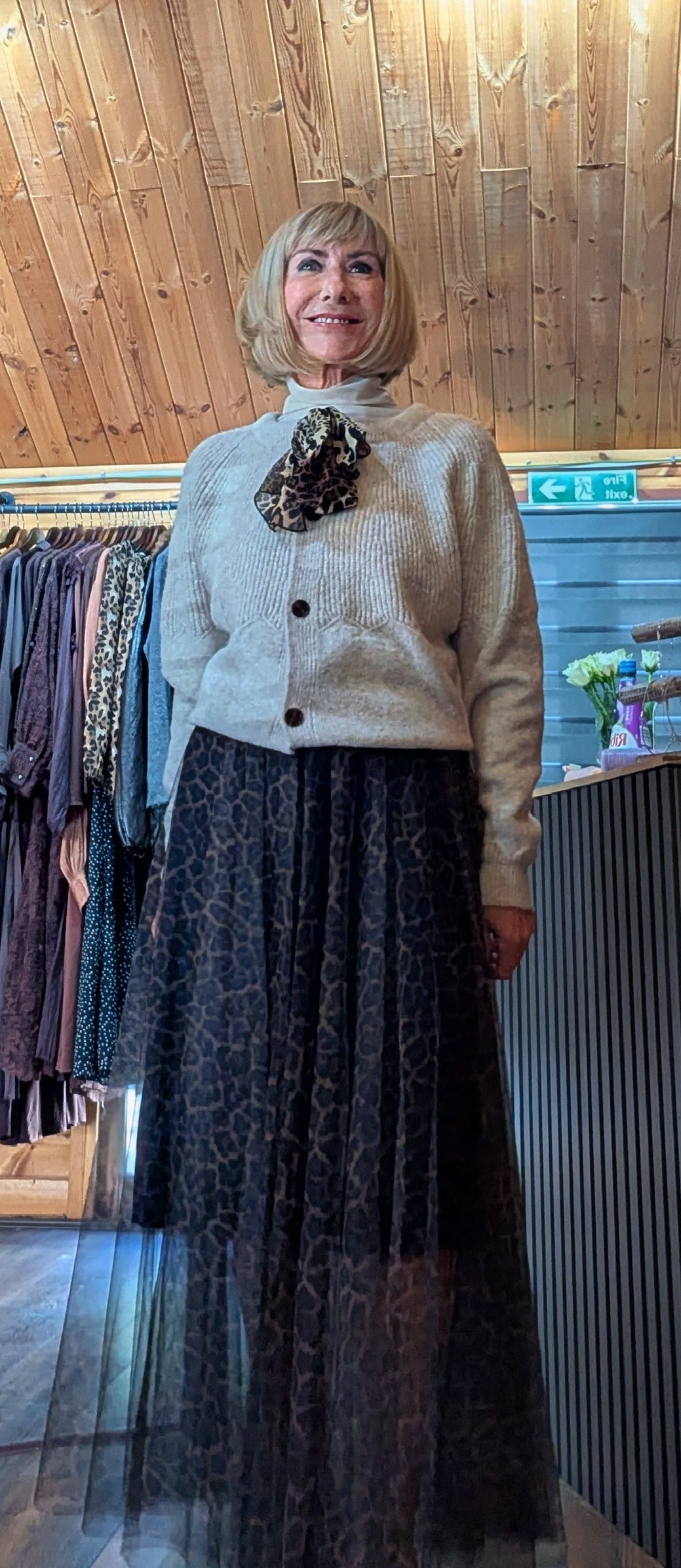 Women’s relaxed knit cardigan with long sleeves and bow neckline worn with a tulle skirt by ditsydi