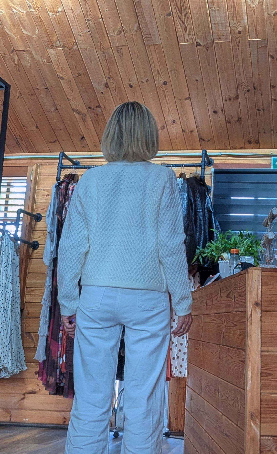 Back view Aviary one size cardigan in soft ivory with statement floral appliqué.
