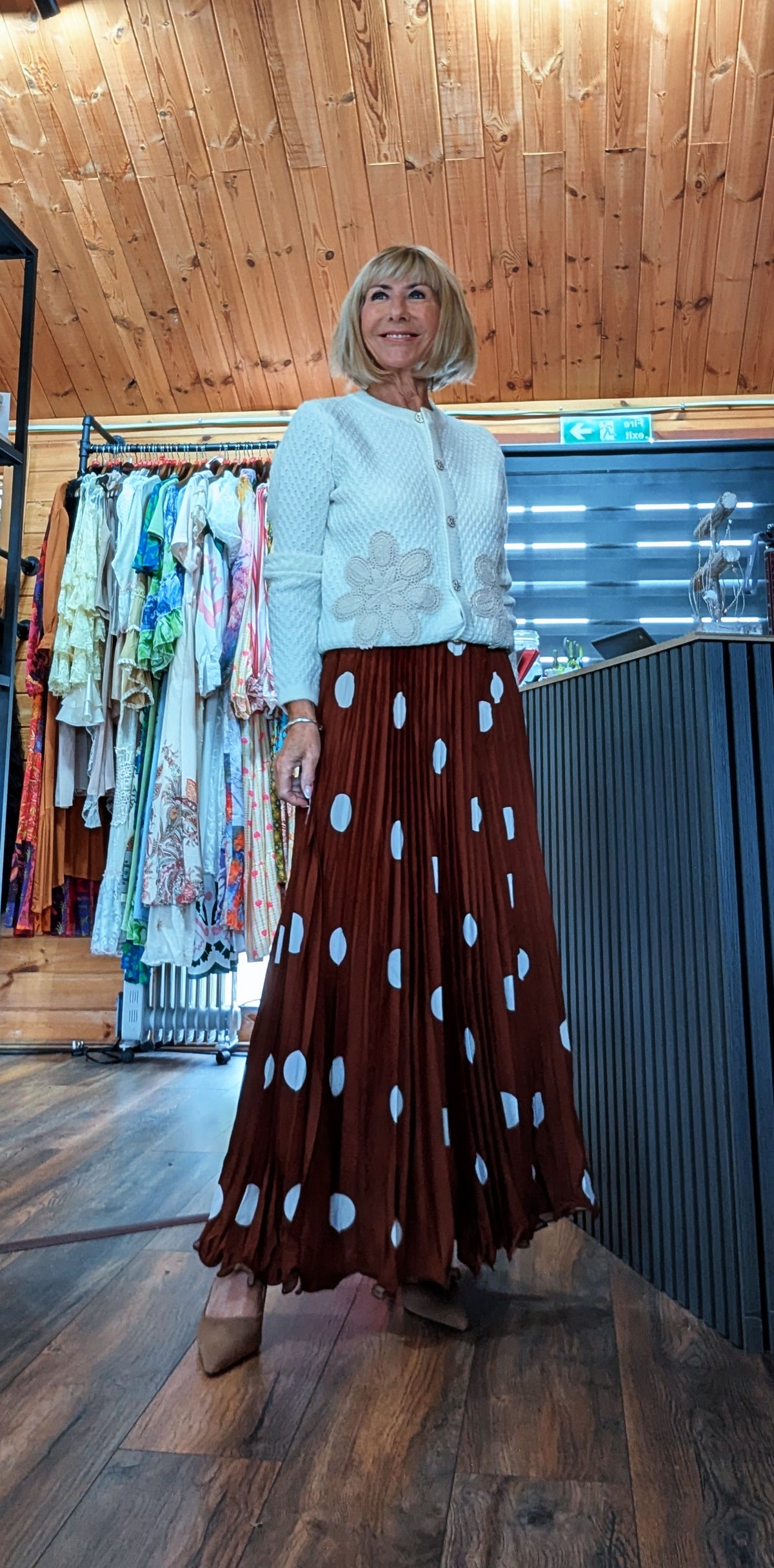 Rust polka dot pleated maxi skirt with elasticated waist styled with a ivory embroidery cardigan