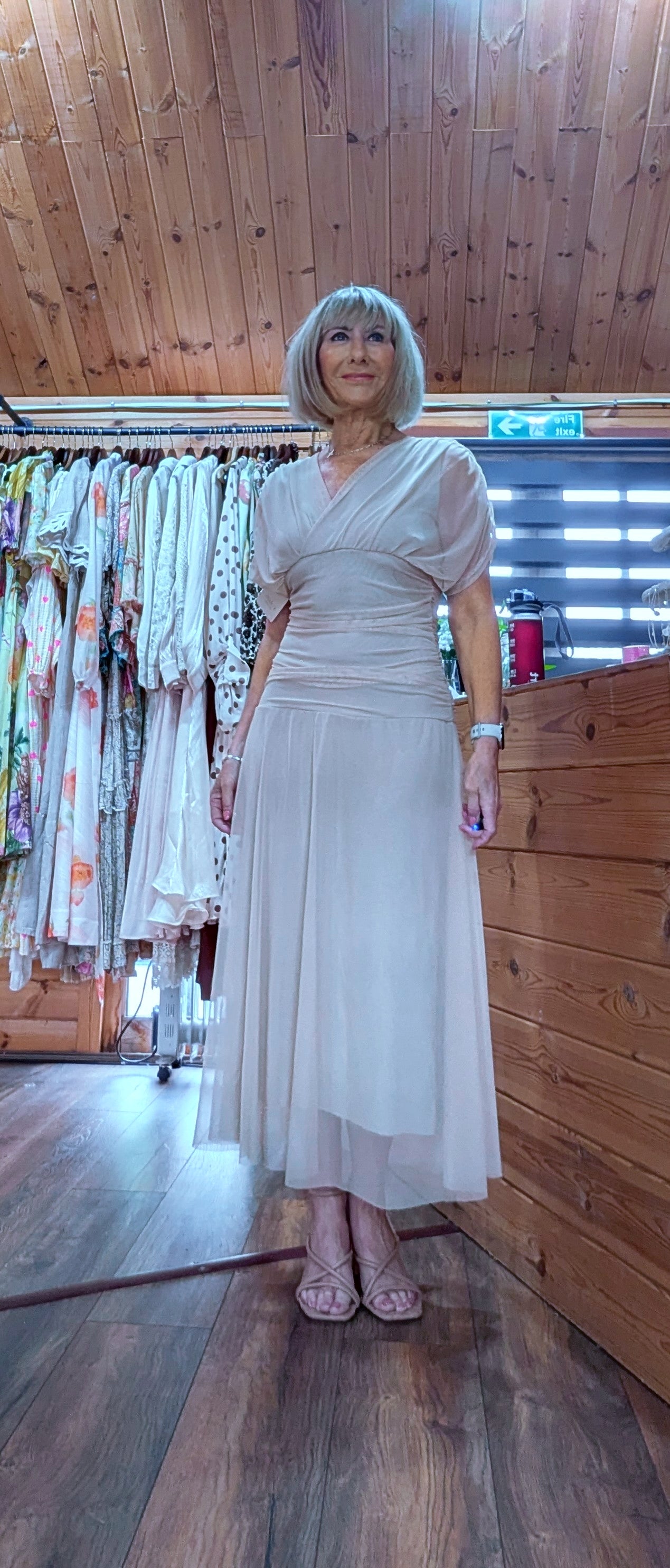 Champagne occasion dress with V neckline and floaty skirt