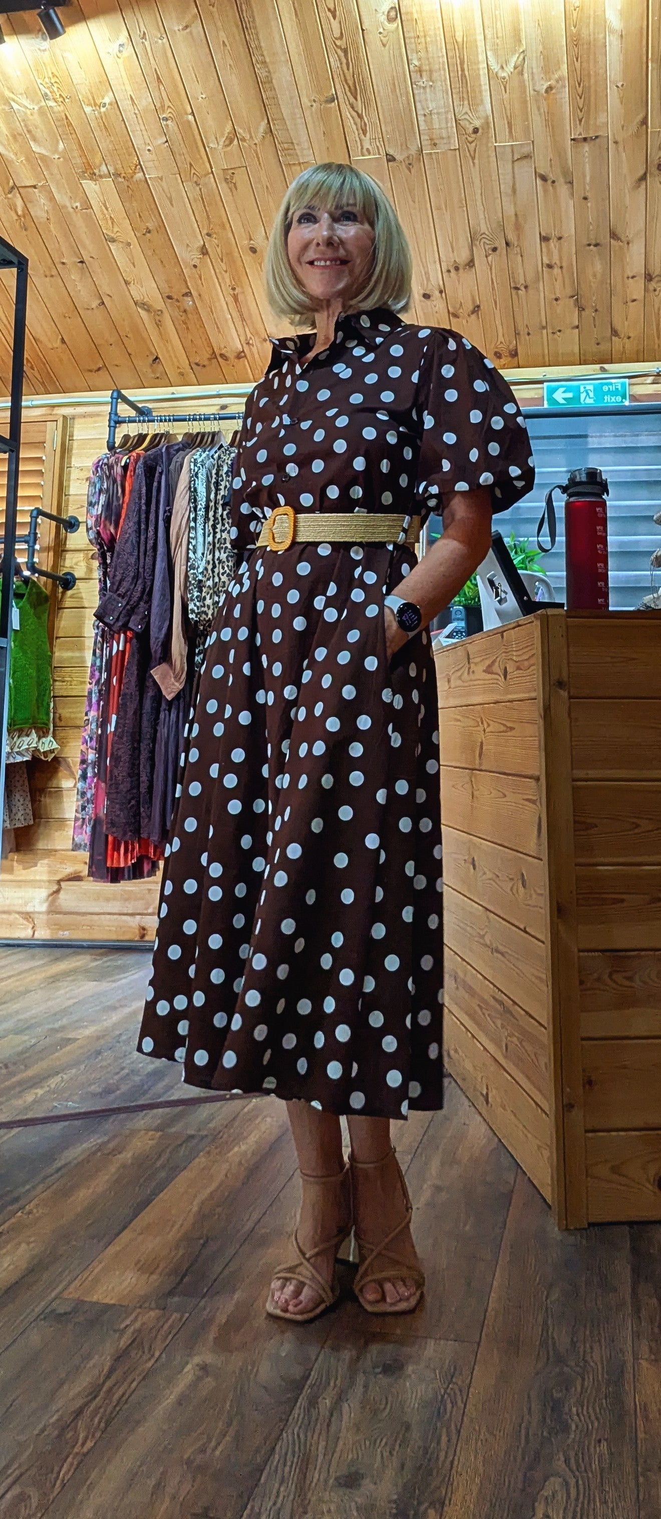 Side view Aoife vintage-inspired brown midi dress styled with a woven belt.