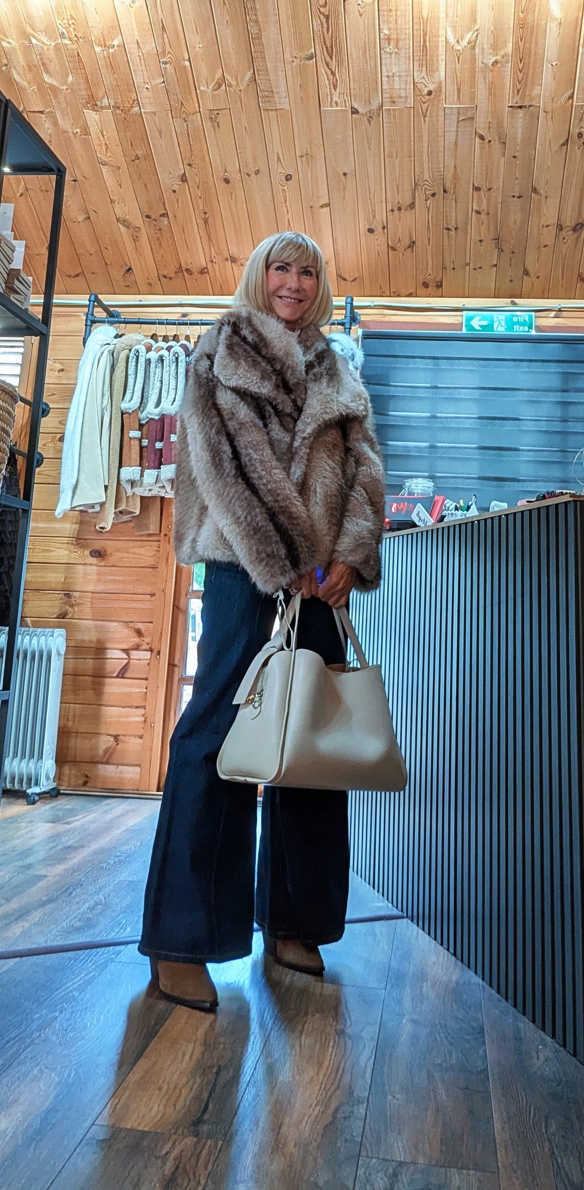 Charlotte chocolate faux-fur coat styled with a cream top and black jeans