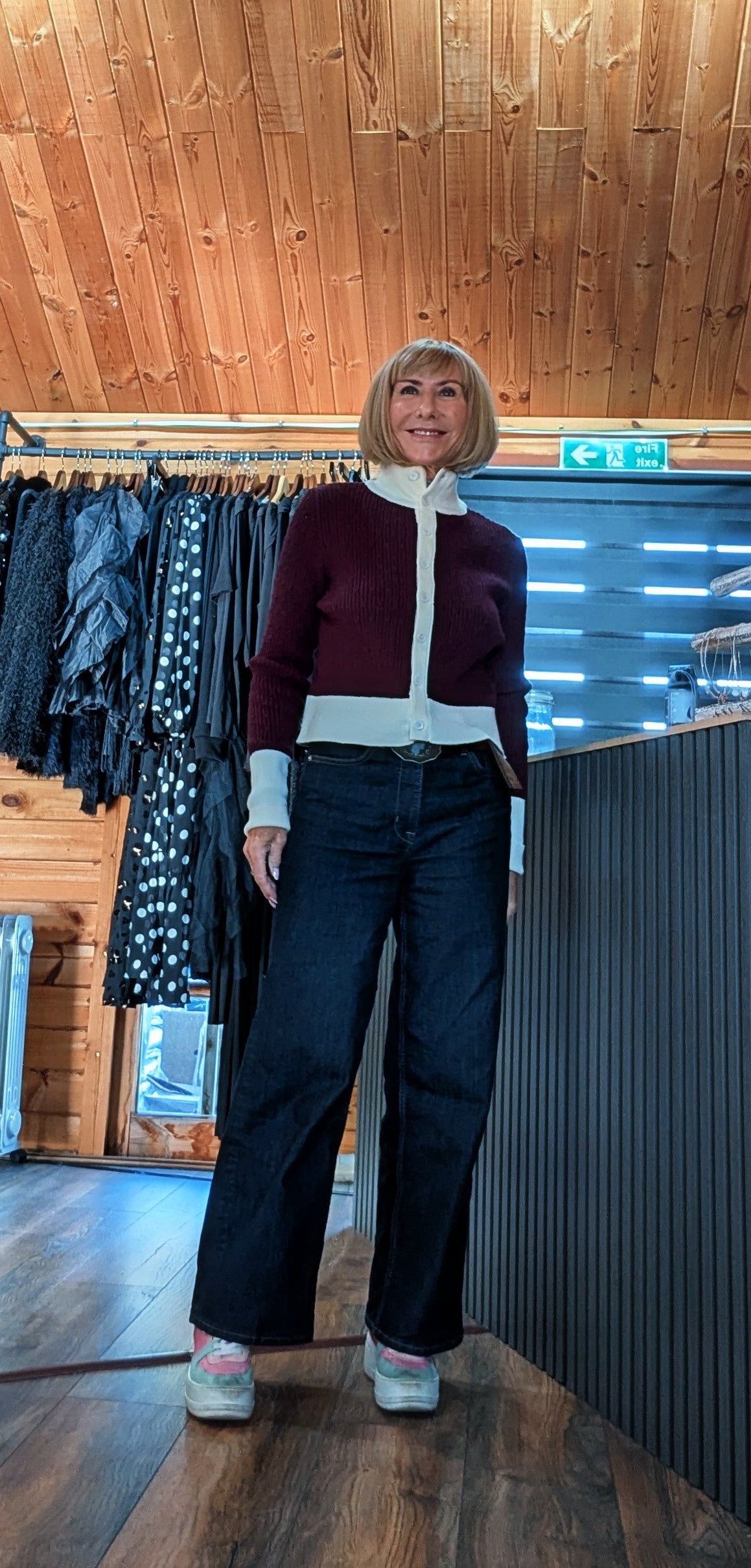 Mallory burgundy cardigan worn buttoned up with dark jeans in the boutique