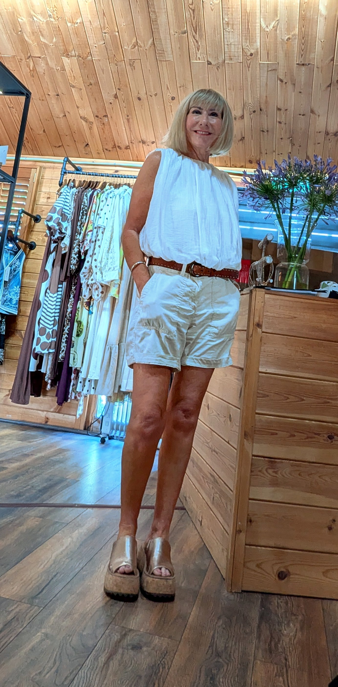 Woman wearing the Francis sleeveless cotton blouse in the DitsyDi boutique.