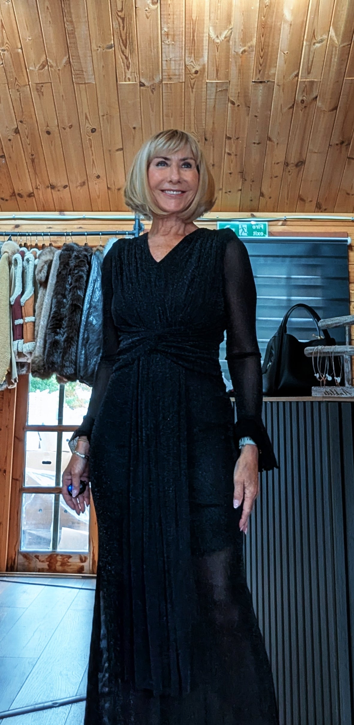 Front view of Shirley black glitter dress showing the lined bodice and draped skirt