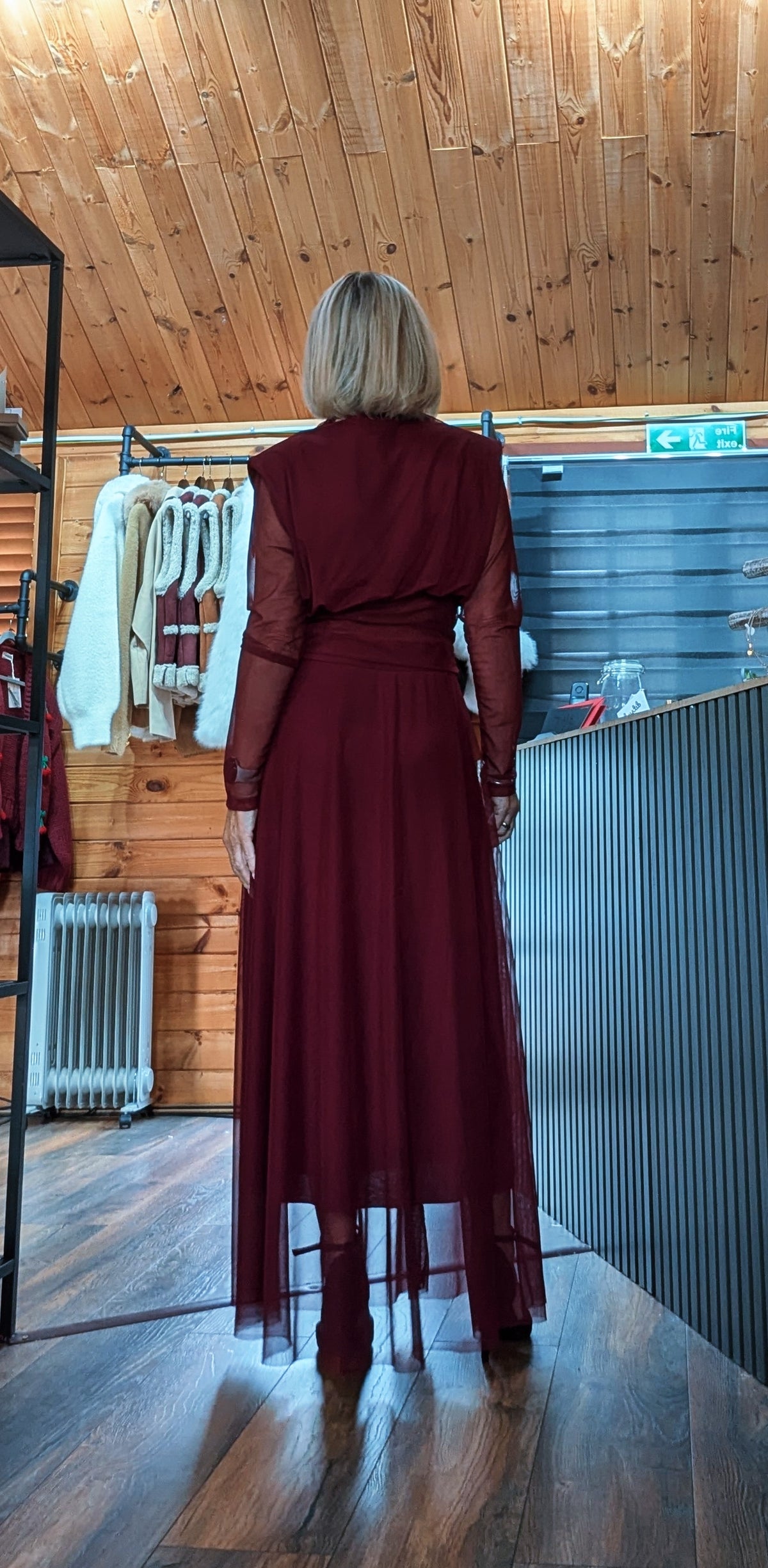 Back view of Harlow burgundy skirt set showing the sheer sleeves and long skirt overlay