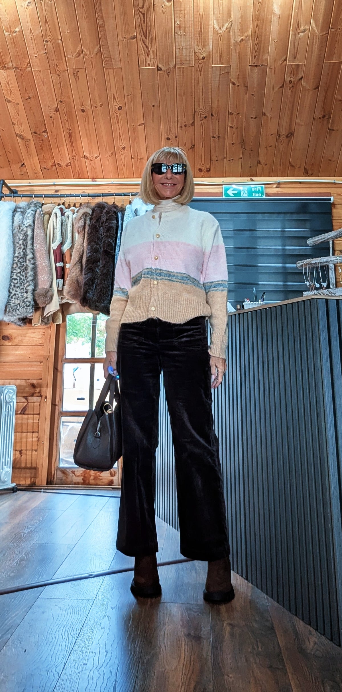 Helen cream, pink and camel colour block cardigan styled with dark trousers, sunglasses and a black handbag