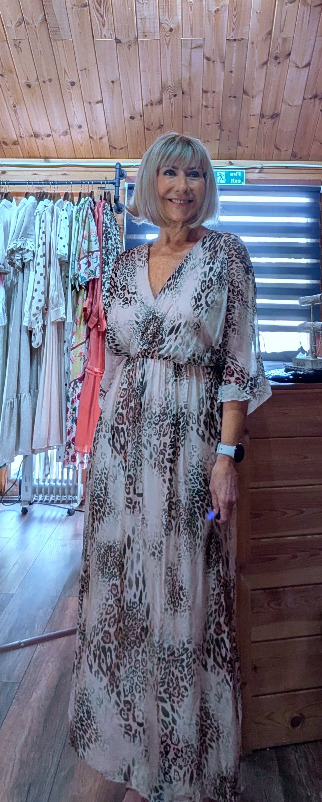 Women's brown animal print silk blend maxi dress with a wrap-effect neckline and three-quarter length sleeves.