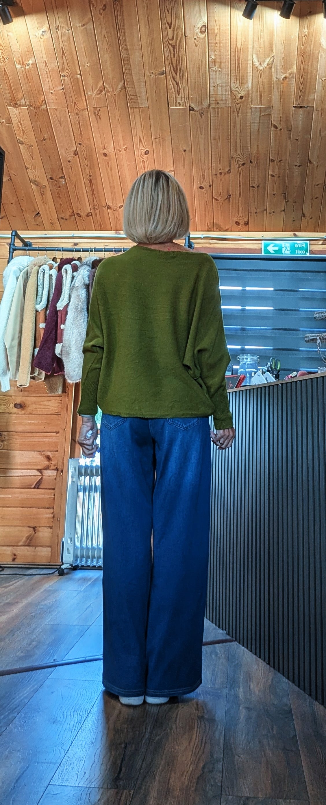 Back view of Pippa one-size relaxed jumper available in olive and burgundy