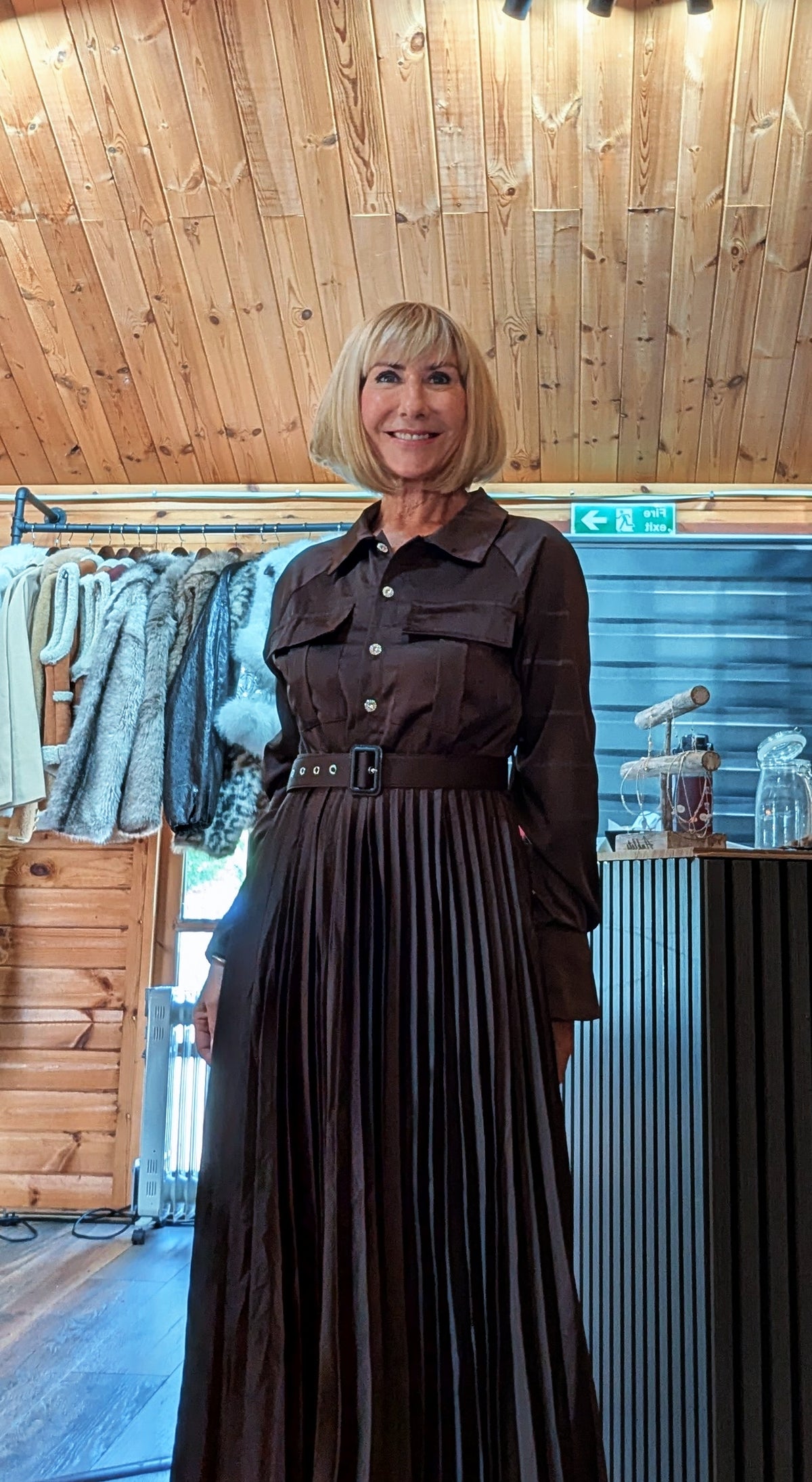 Full-length Meryl chocolate dress with long sleeves and a flowing pleated maxi skirt
