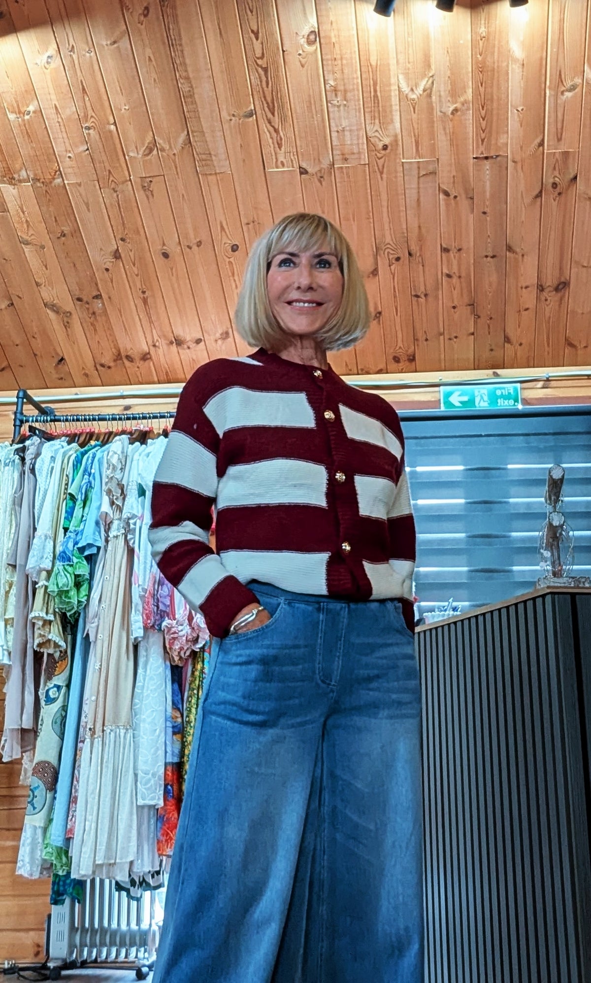 Close up view Women’s striped knitted cardigan in burgundy
