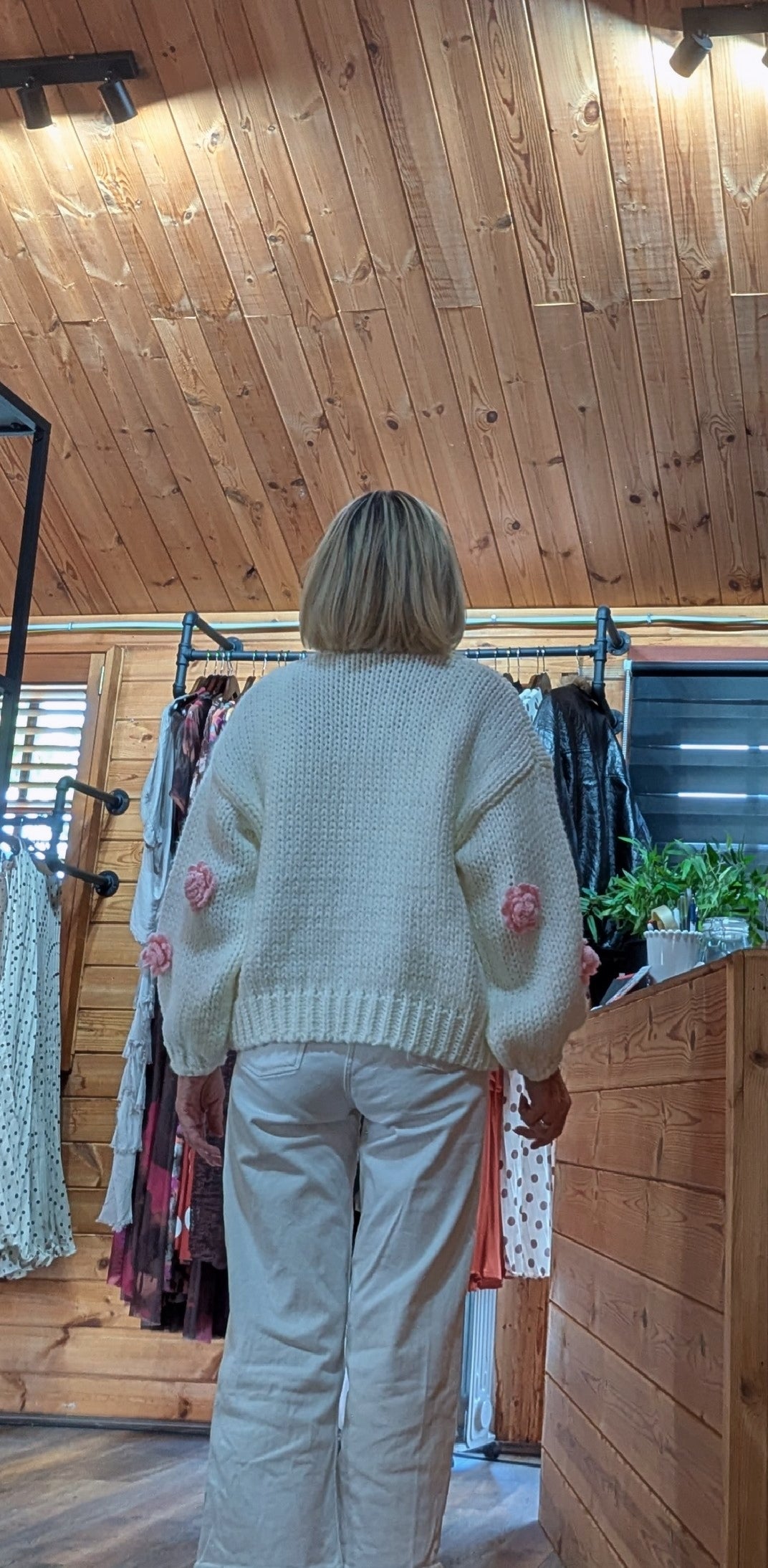 Women’s ivory chunky knit cardigan with soft pink flower details rear