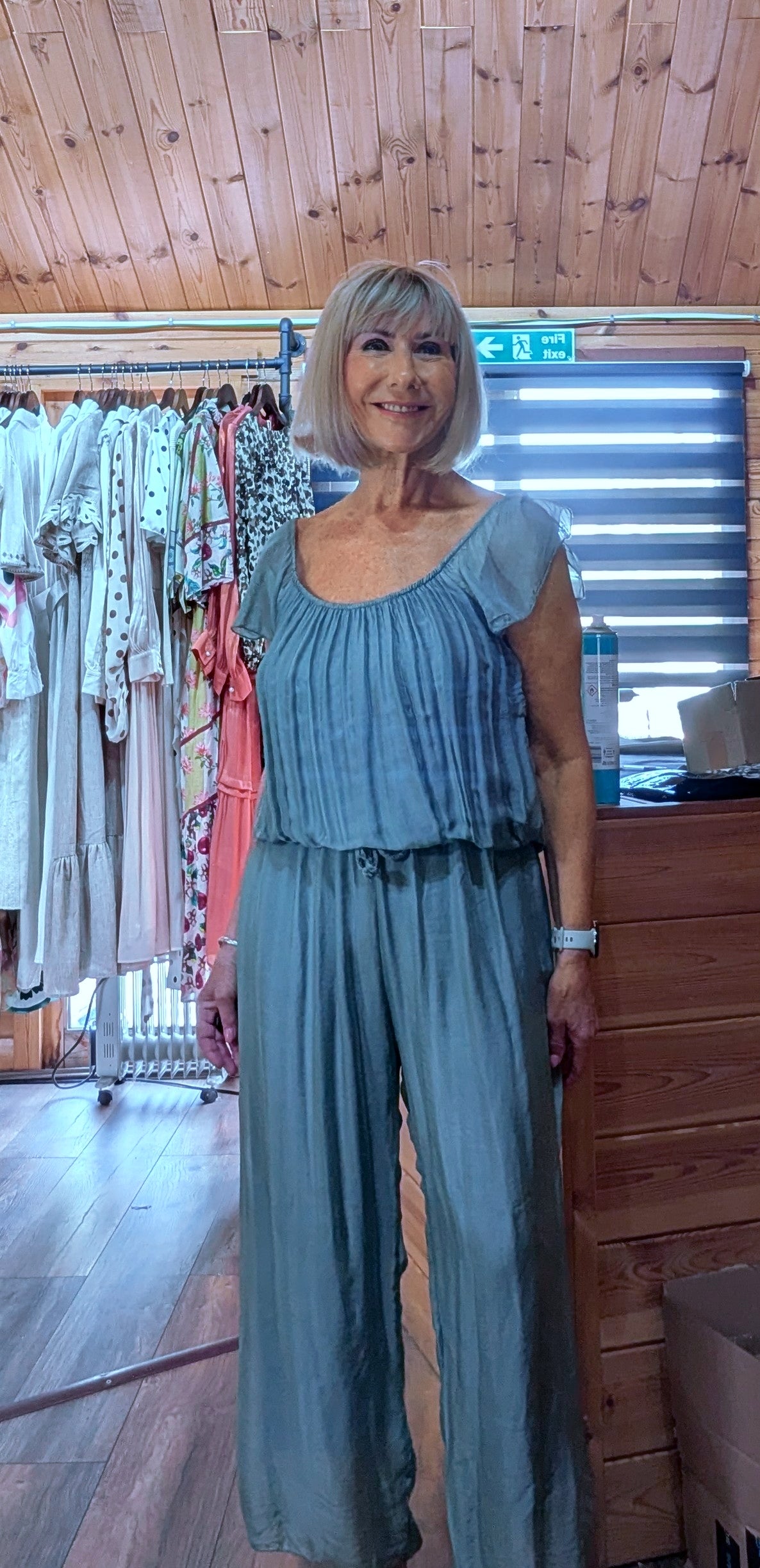 Front view of the Jess aqua silk blend jumpsuit with a soft draped silhouette, elasticated waist and wide-leg design.
