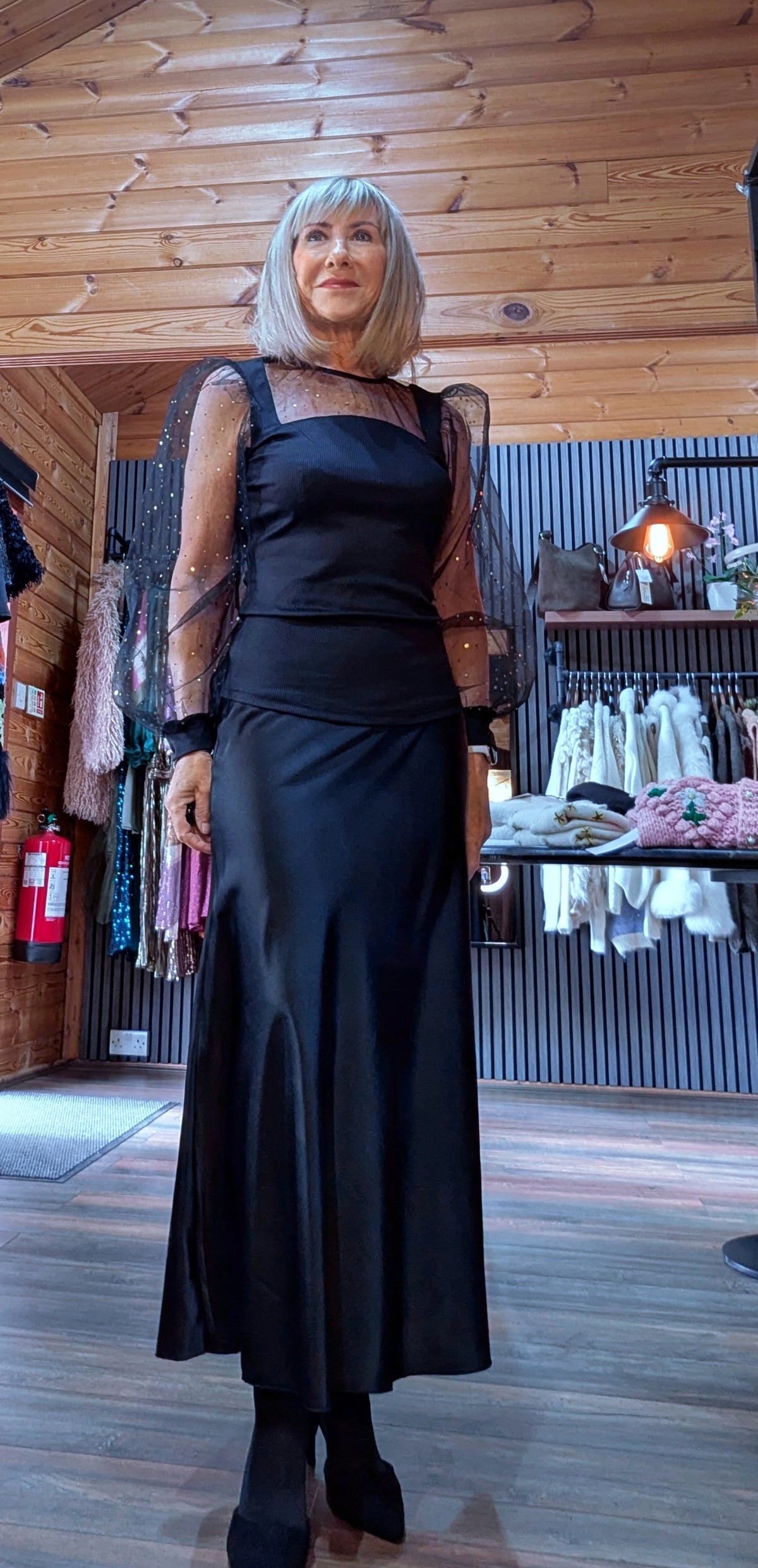 Full-length outfit featuring Sia black organza-sleeve top and a black skirt