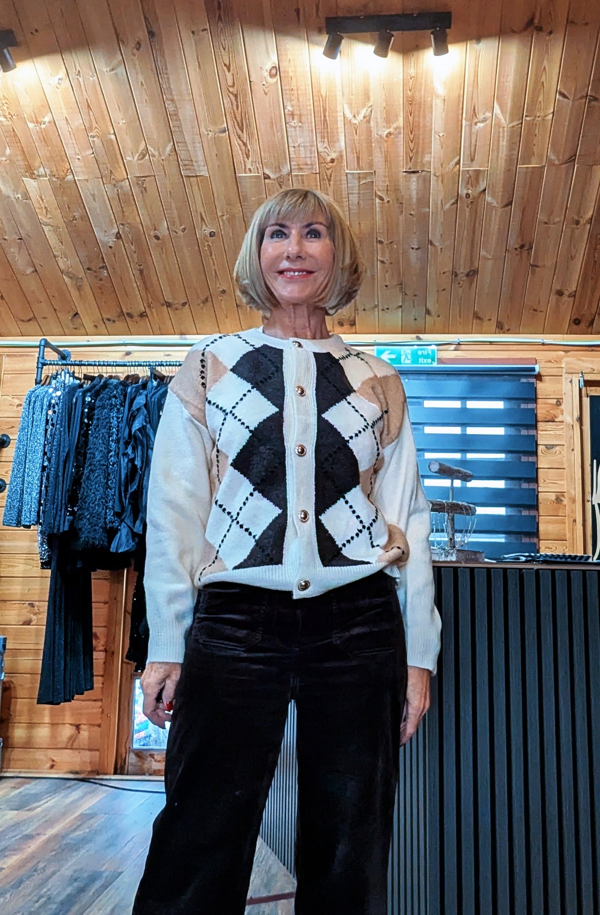 Detail view of the Irene cardigan, showing the round neckline and diamond pattern