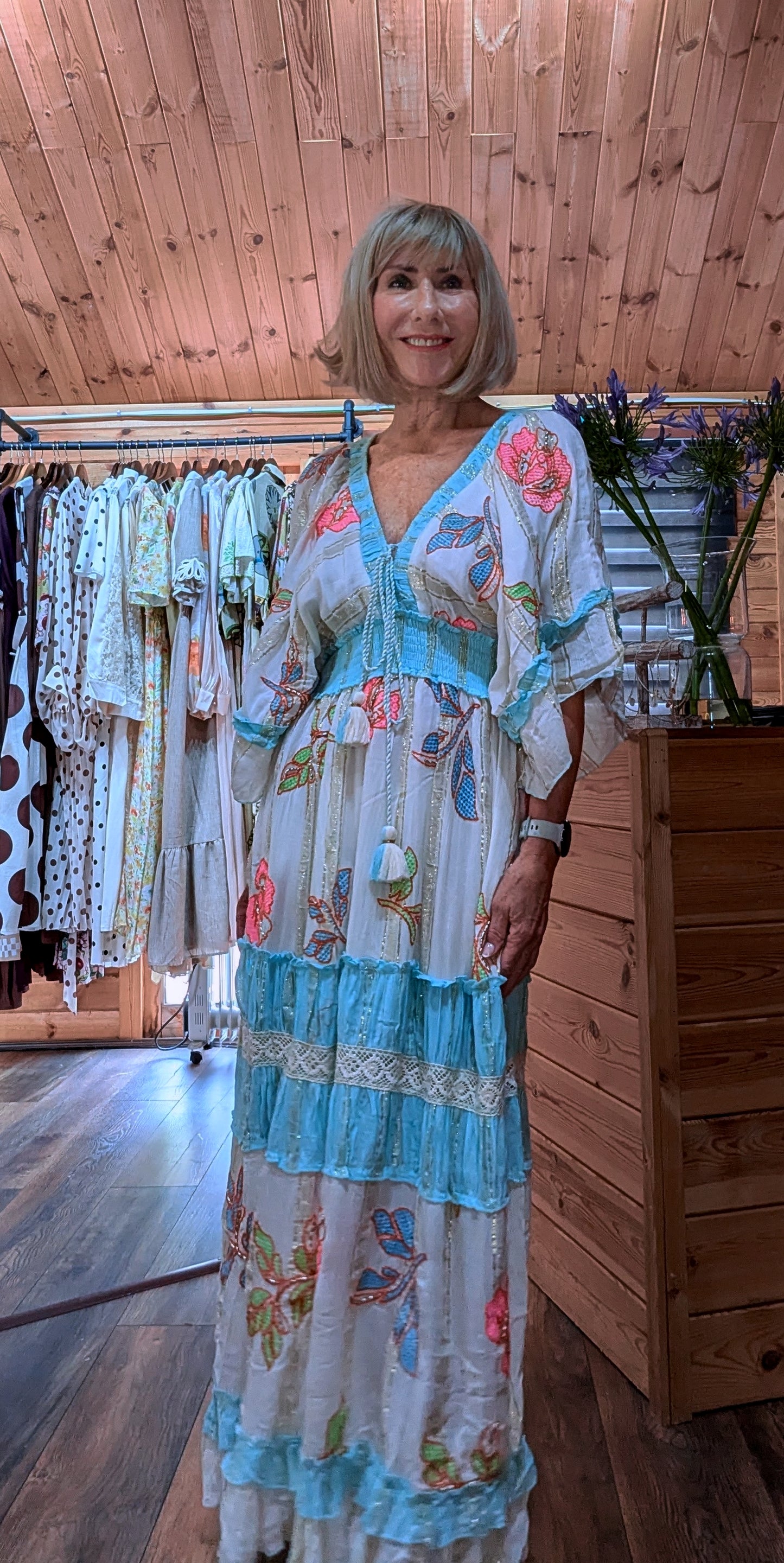 Lucy flowing holiday maxi dress with batwing sleeves and a tiered skirt.