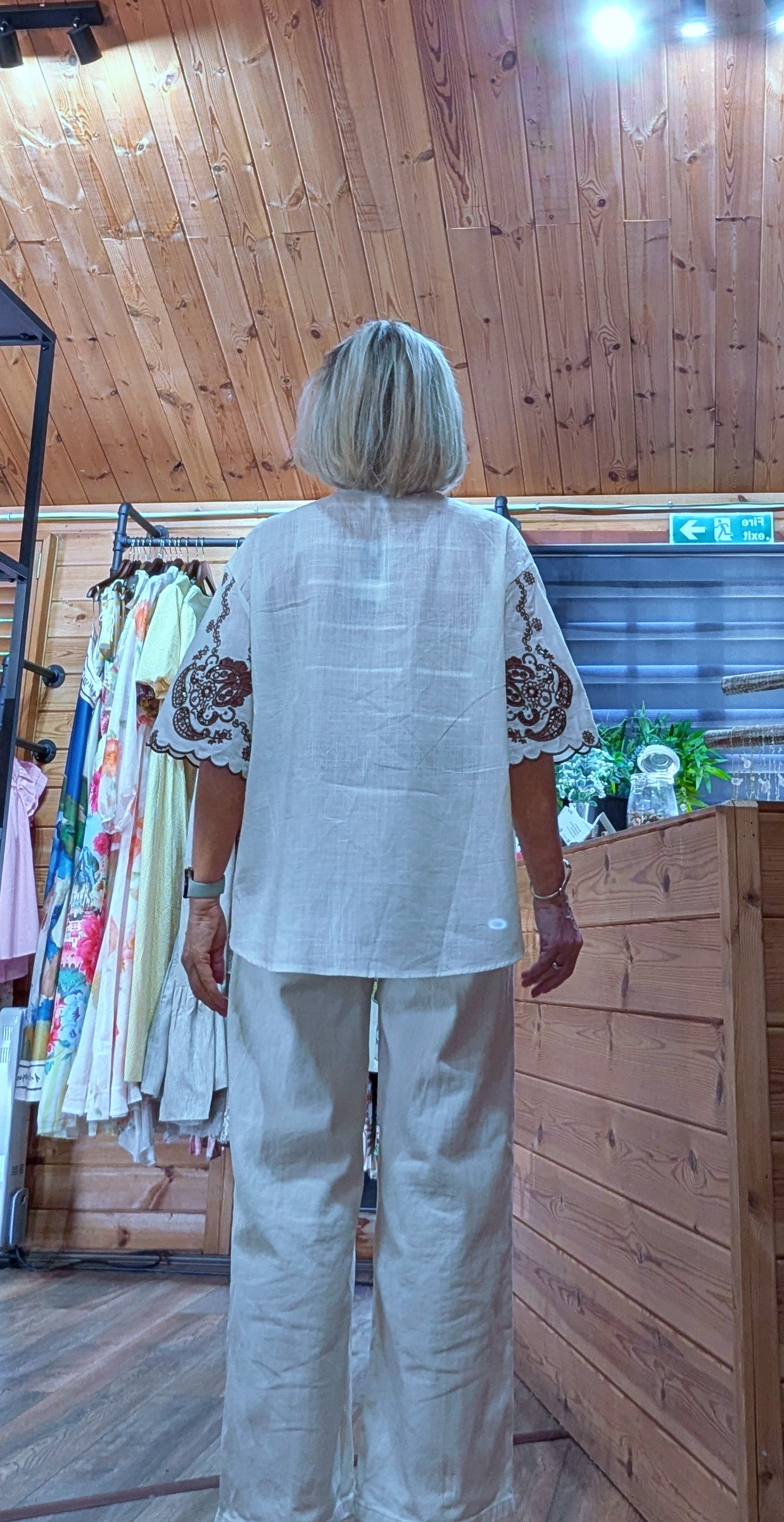 Back view of Daryl Cotton Blouse with chocolate embroidery