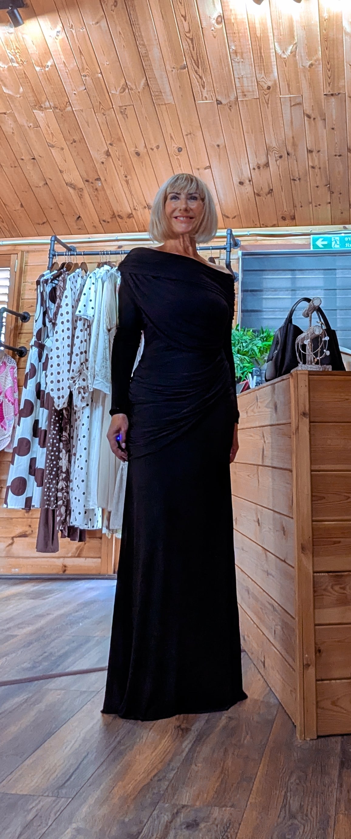 Front view of the Tilda black full-length occasion dress with long sleeves.