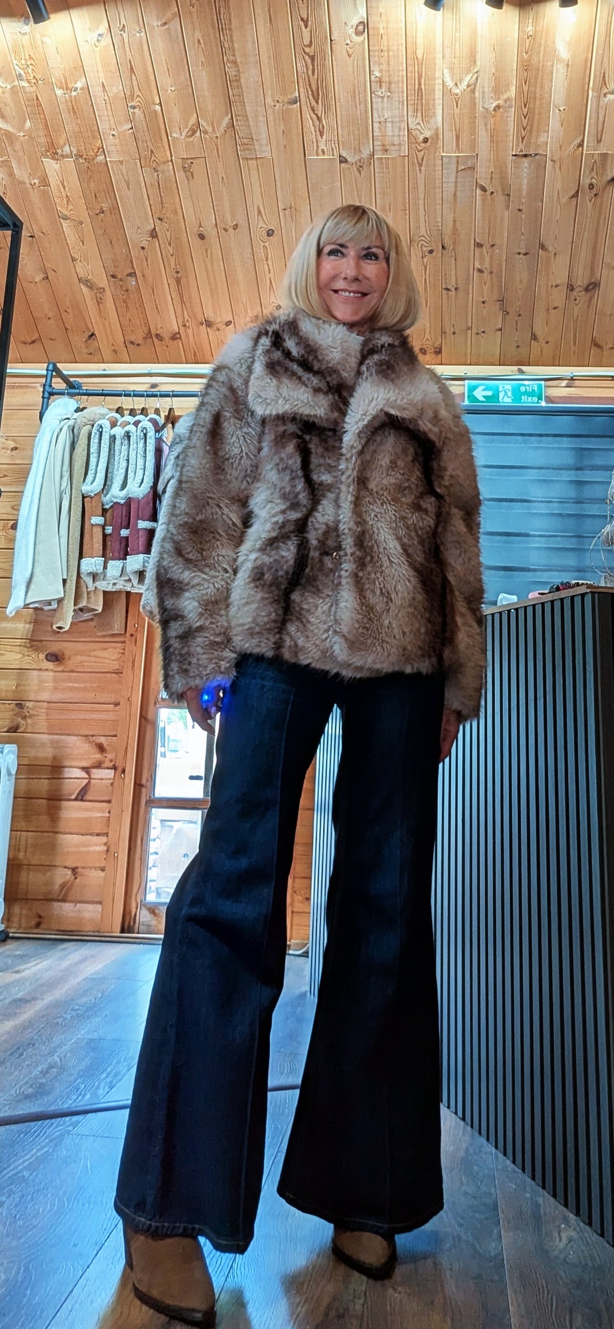 Full length view of ditsydi wearing a faux fur jacket with statement collar