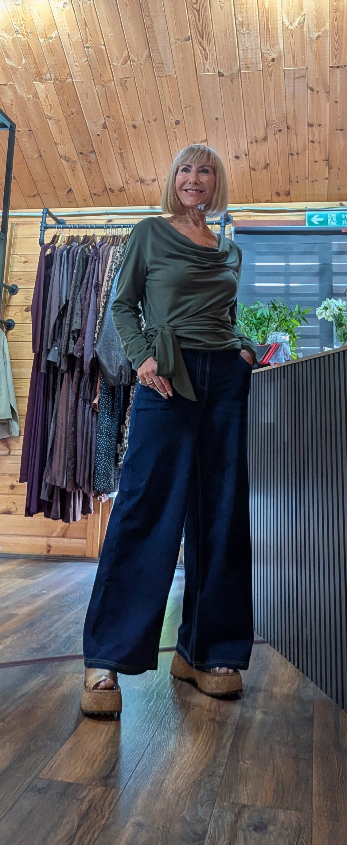 Freya khaki long sleeve top with side knot detail worn with wide leg jeans