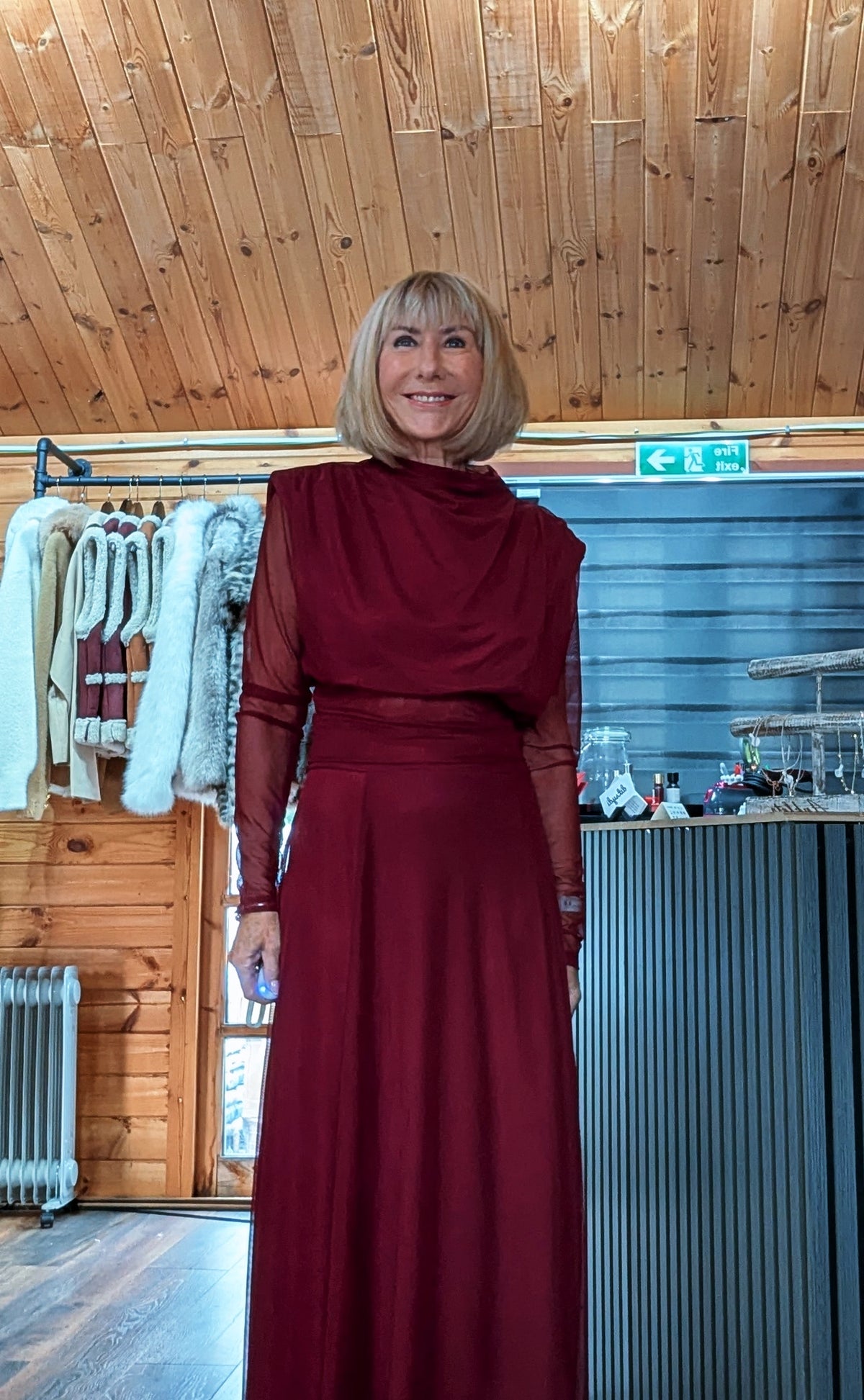 Closer front view of Harlow burgundy high-neck top with long sheer sleeves and matching skirt