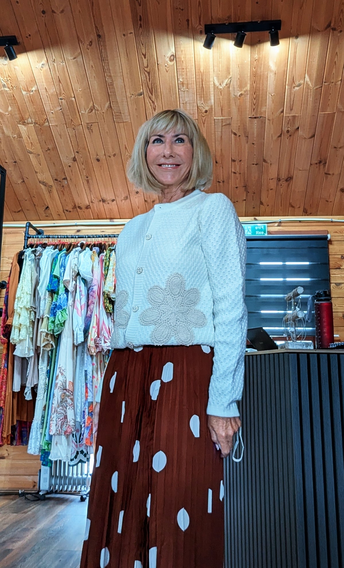 Aviary ivory cardigan with gold button front and embroidered floral detail worn with Trinny skirt