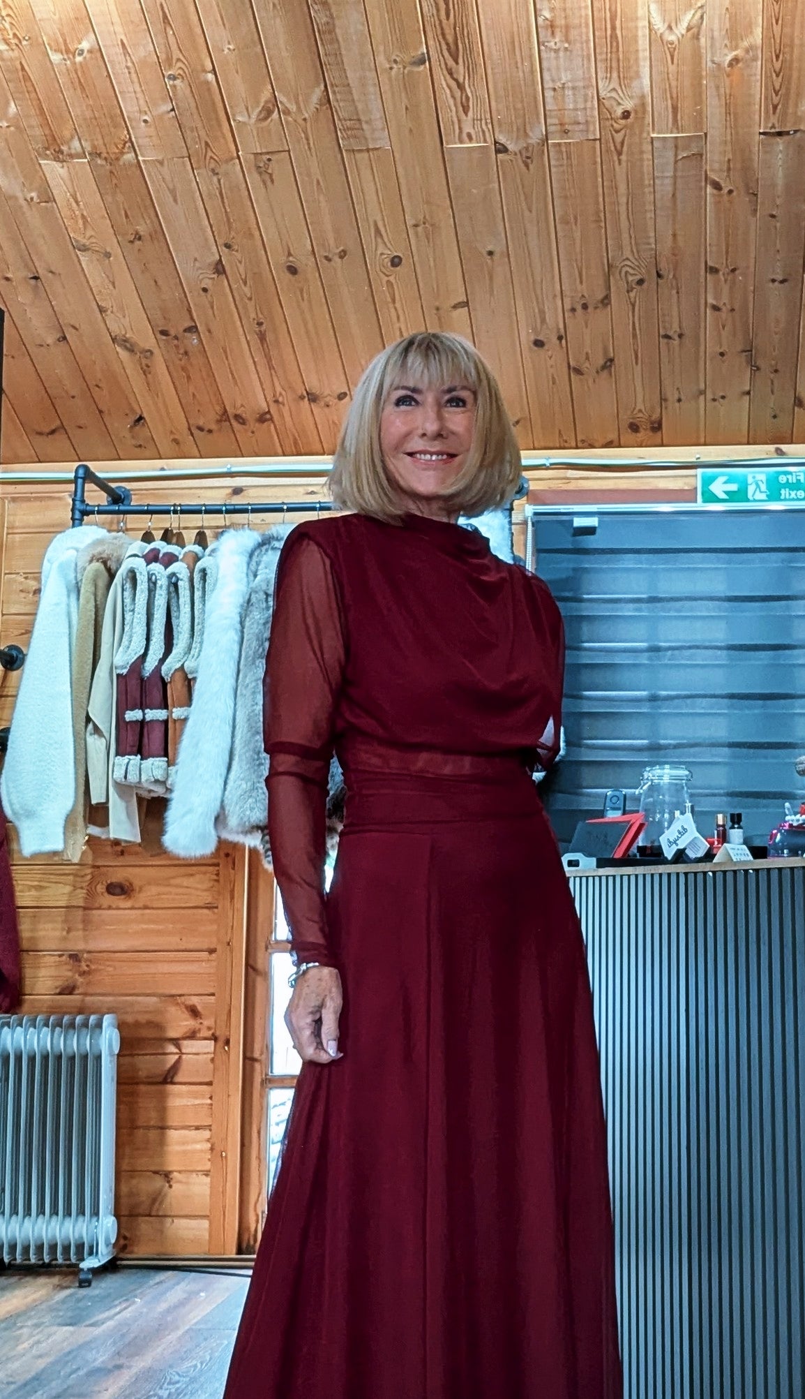 Three-quarter view of Harlow burgundy set showing the draped neckline and sheer sleeve