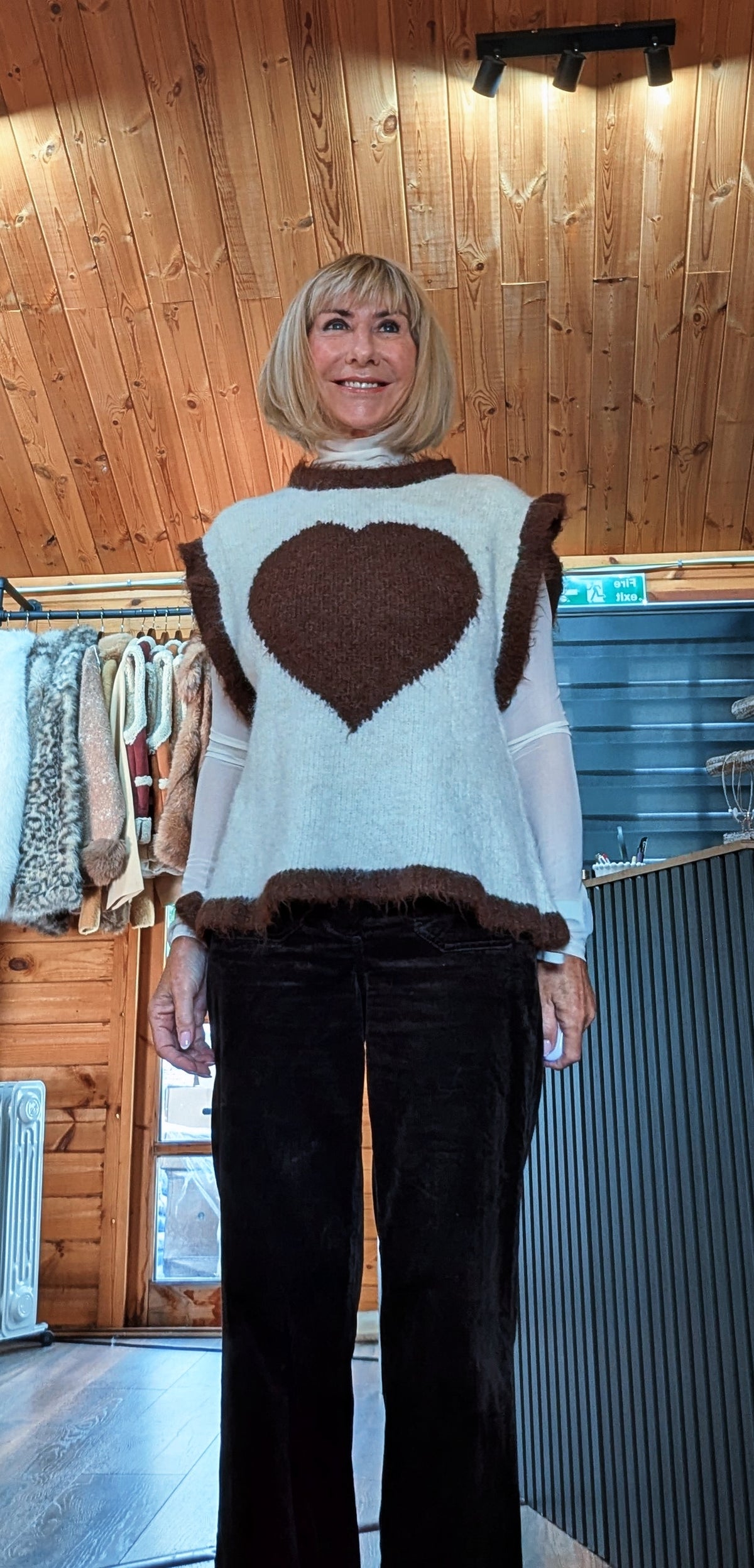 Front view of Maura sleeveless sweater showing its relaxed shape and contrast edging