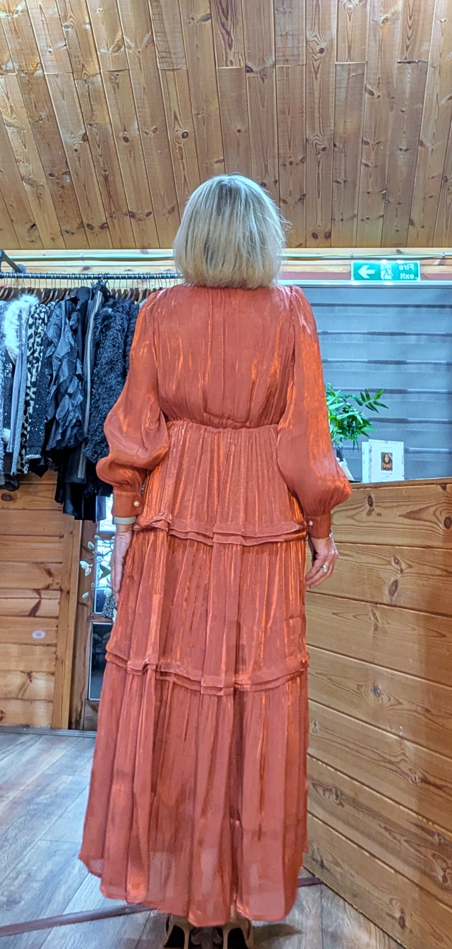 Women’s fully lined tiered midi dress in rust rear view
