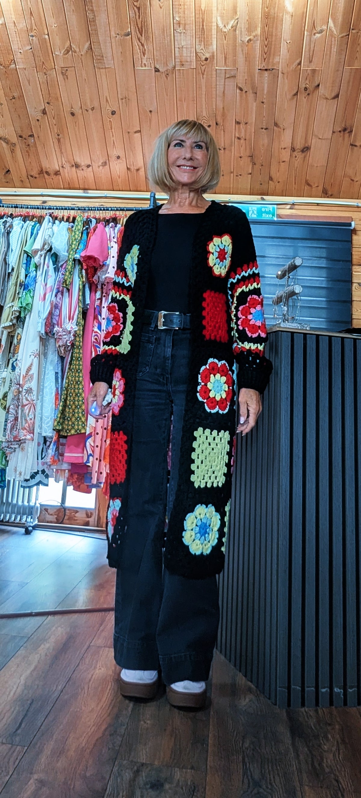 Fia black longline cardigan with colourful crochet-style flower squares, one size UK 8–14
