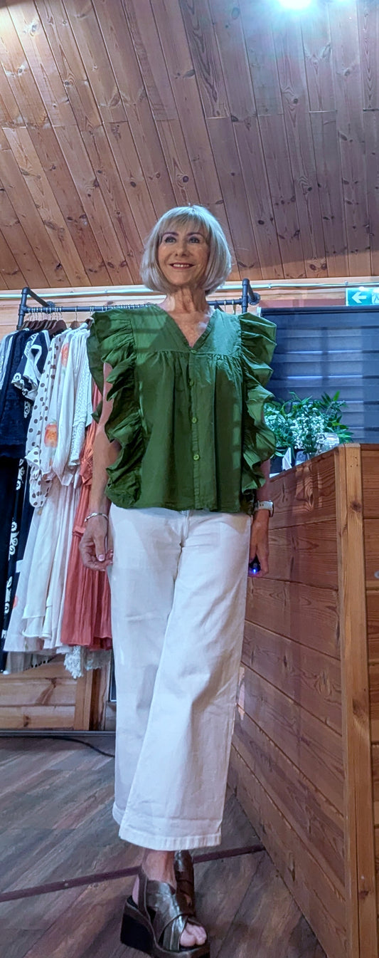 Penelope Olive Cotton Frill Blouse paired with white jeans