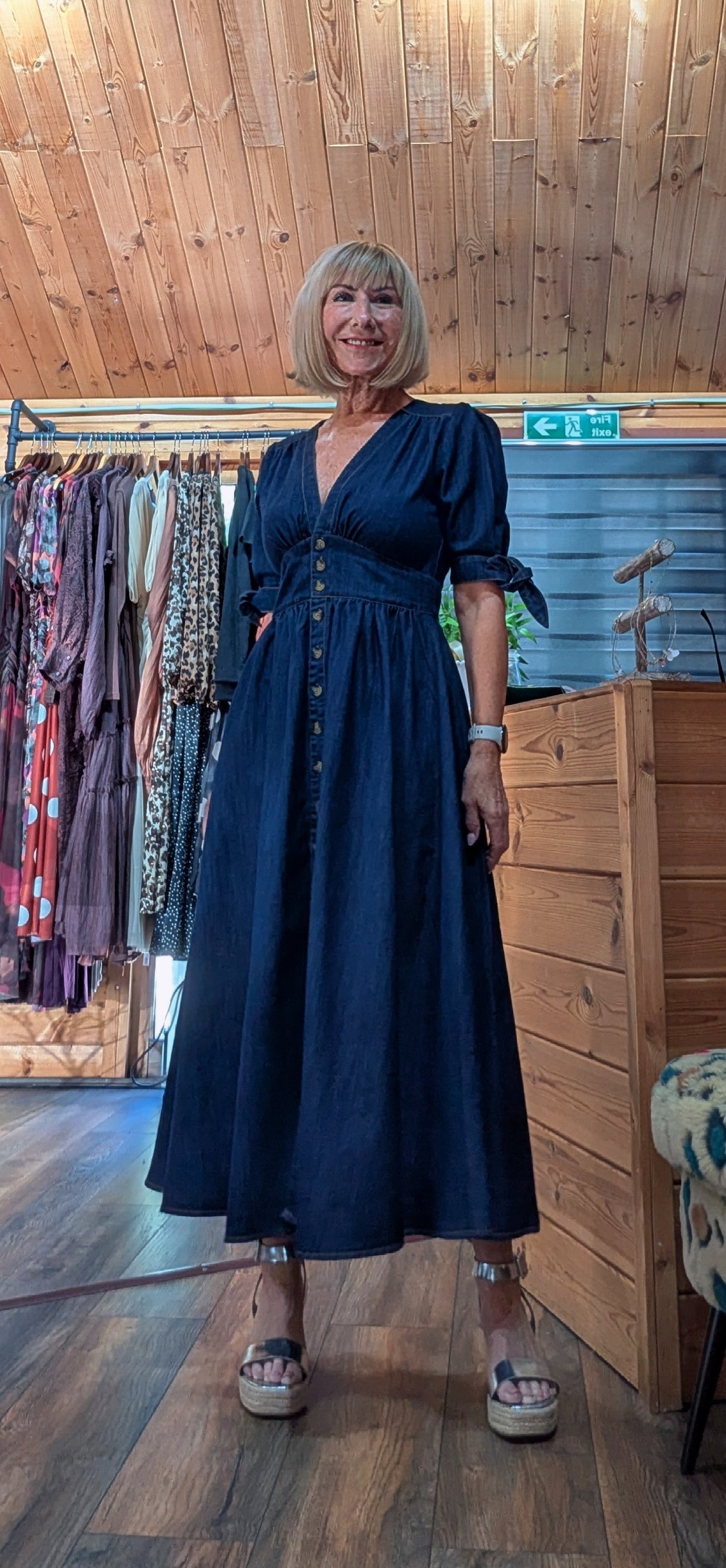 ditsydi wearing our Binty dark navy blue denim midi dress with a buttoned front and puff sleeves. 