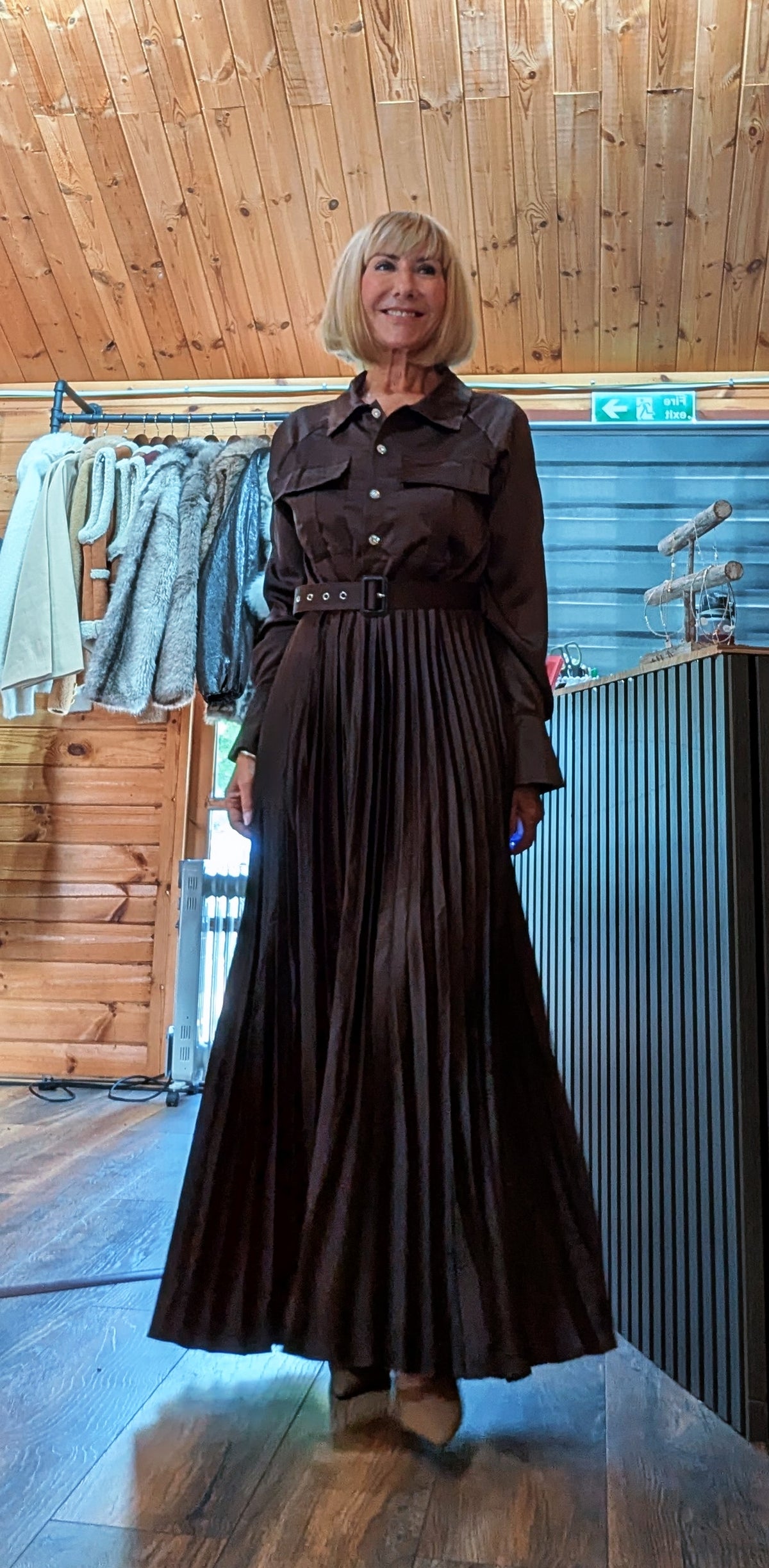 Meryl chocolate pleated maxi dress styled with pointed-toe heels
