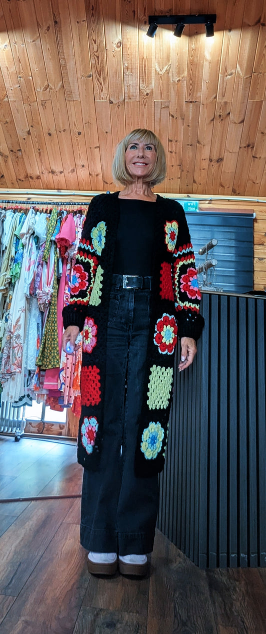 Fia black longline cardigan with colourful crochet-style flower squares, one size UK 8–14
