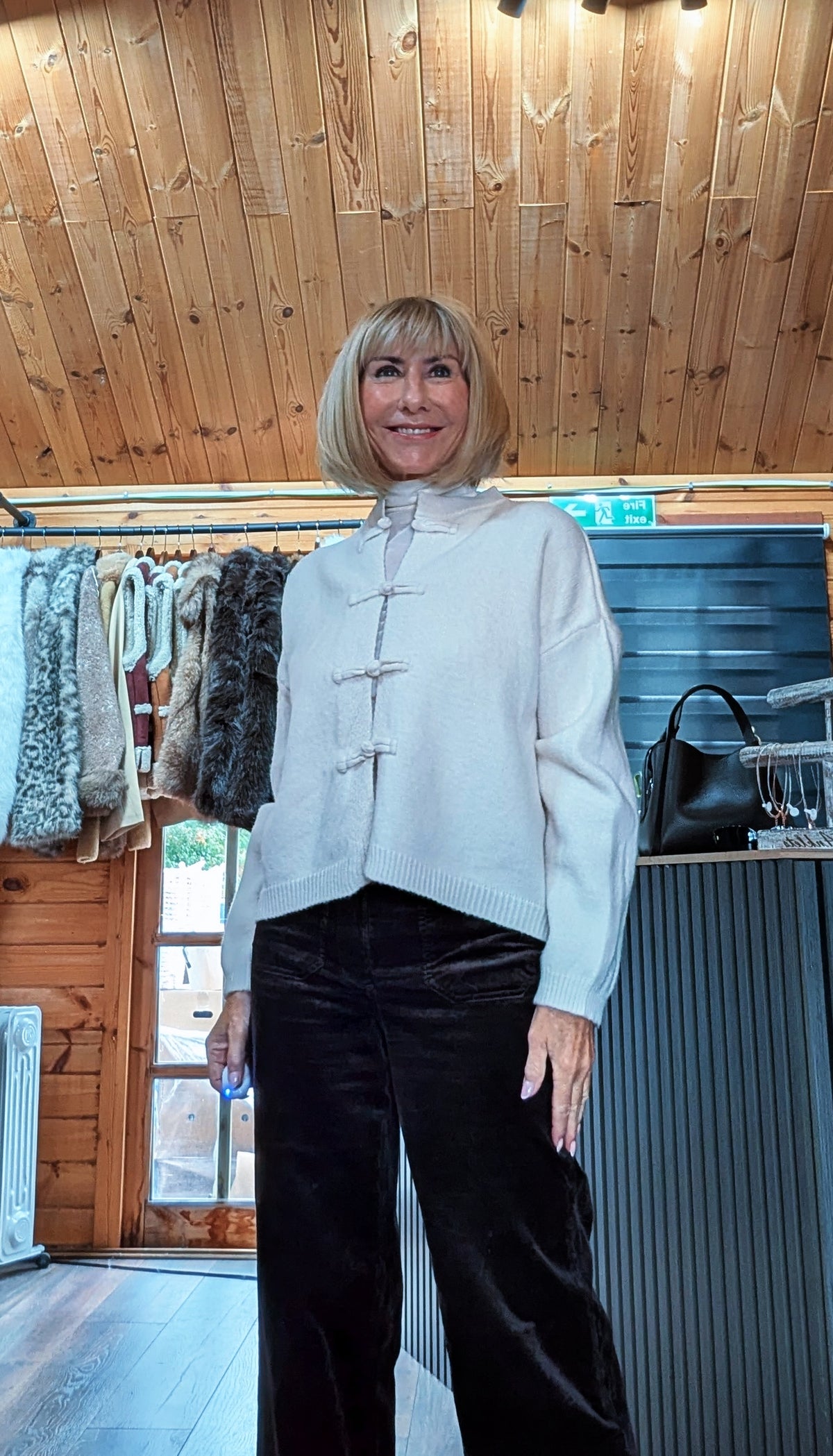 Fran cream knitted cardigan showing the decorative knot fastenings and long sleeves