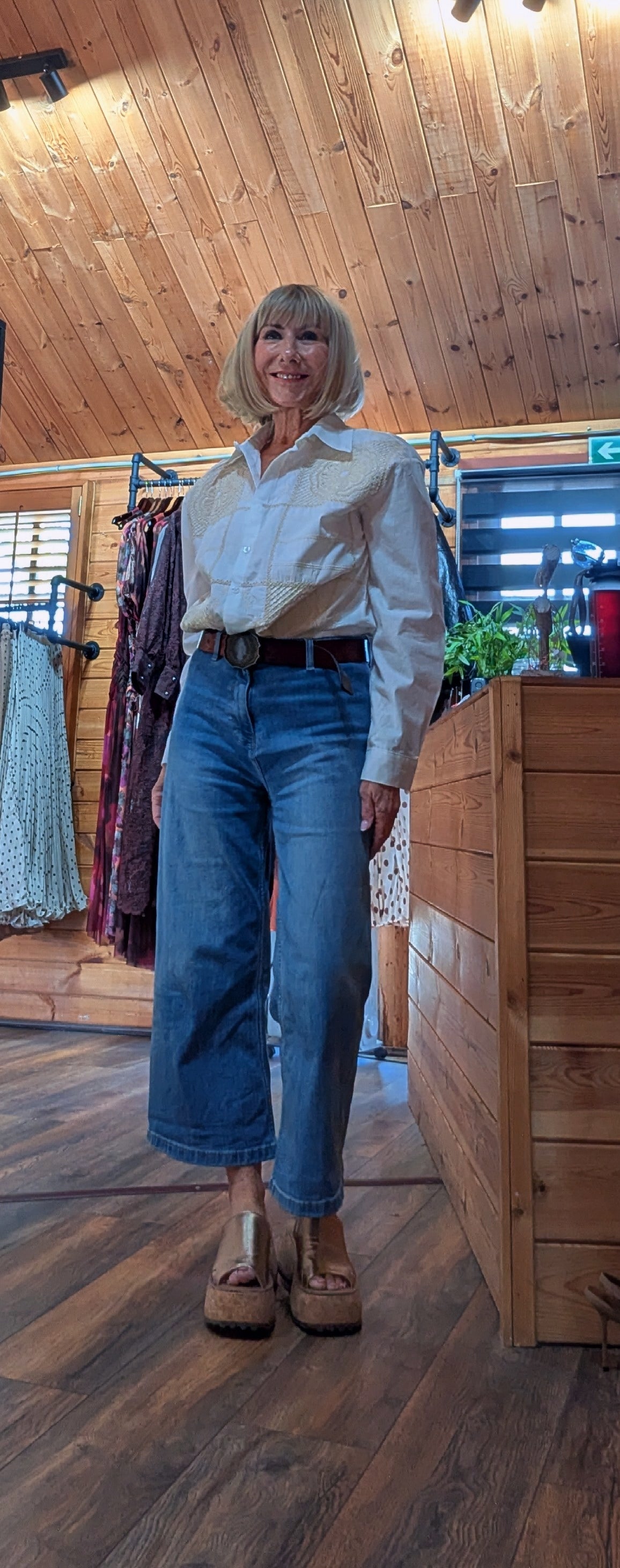 Classic white cotton blouse with embroidery panelling styled with cropped flared blue demin jeans 